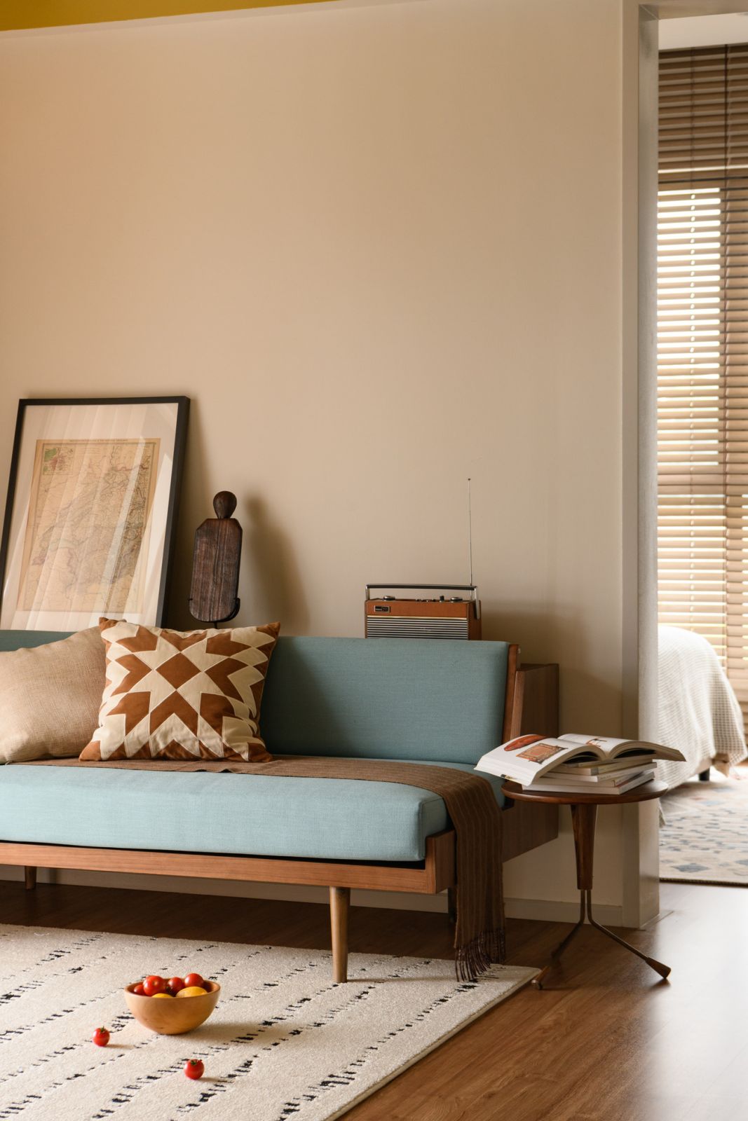 Mid-century inspired furniture pieces, including a pale blue daybed and geometric cushions, bring retro charm to the family room
