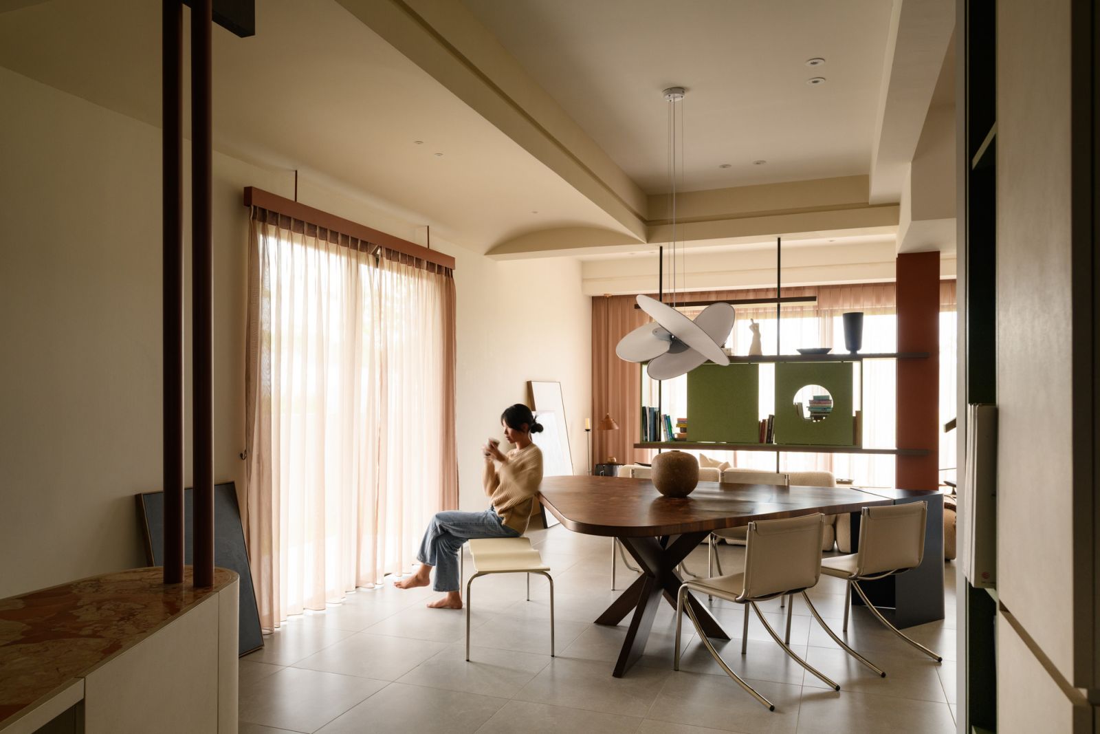 Thoughtful material transitions create visual interest throughout the space, with warm wood tones balancing the neutral palette