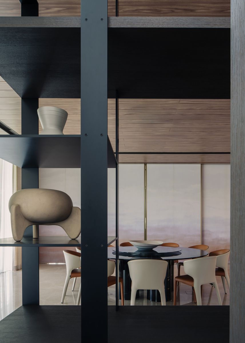 The informal dining room features gentle hues on the artwork on its doors