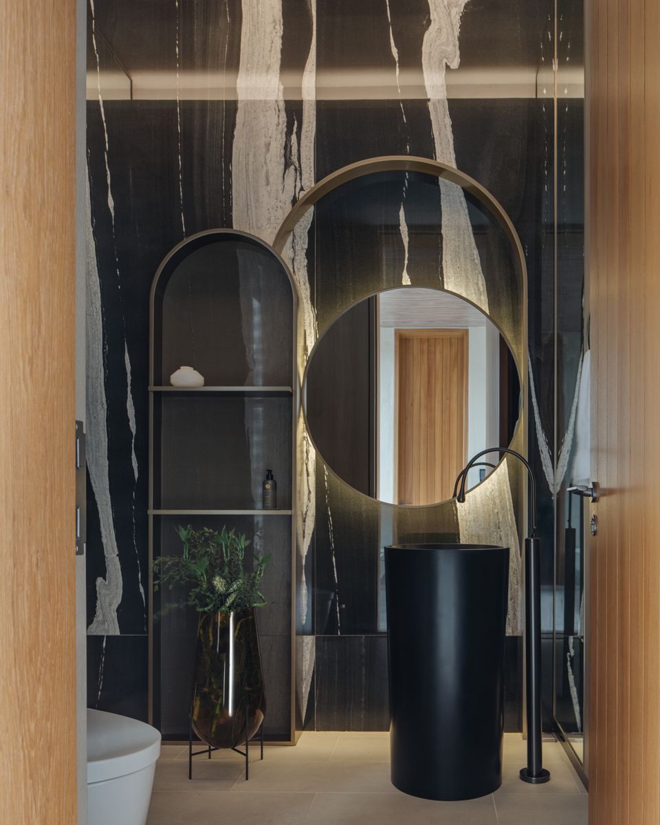The level 1 powder room is, too, finished with sumptuous materials