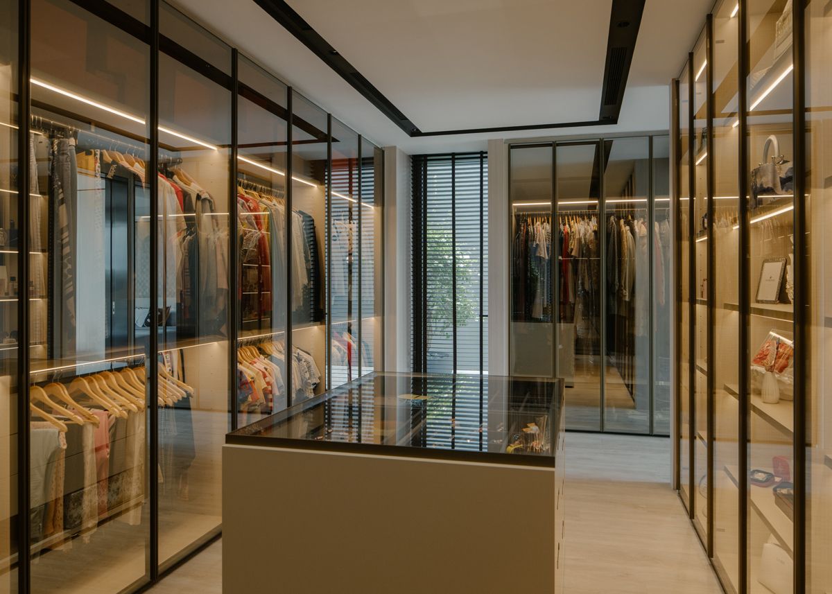 The glazed and subtly lit master wardrobe facilitates ease of organisation