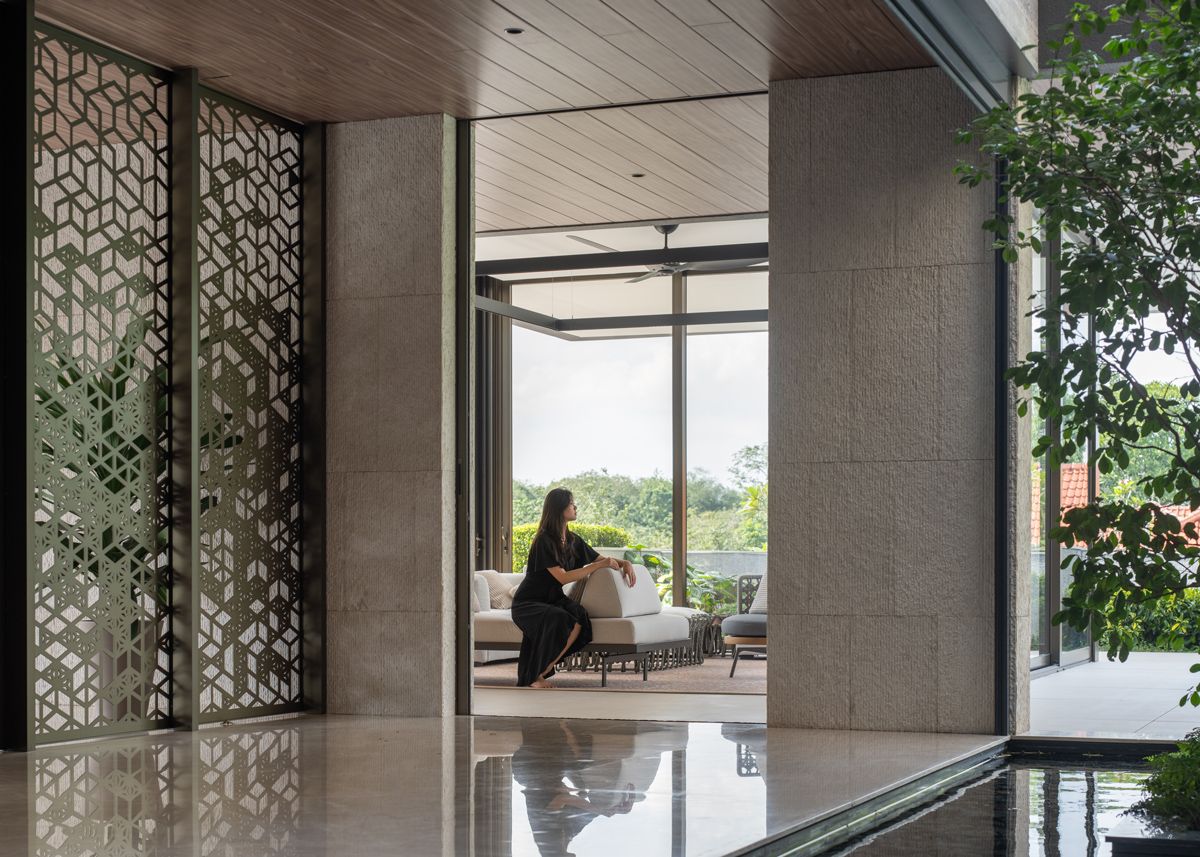 Custom perforated screens mediated the indoor and outdoor areas of the Good Class Bungalow
