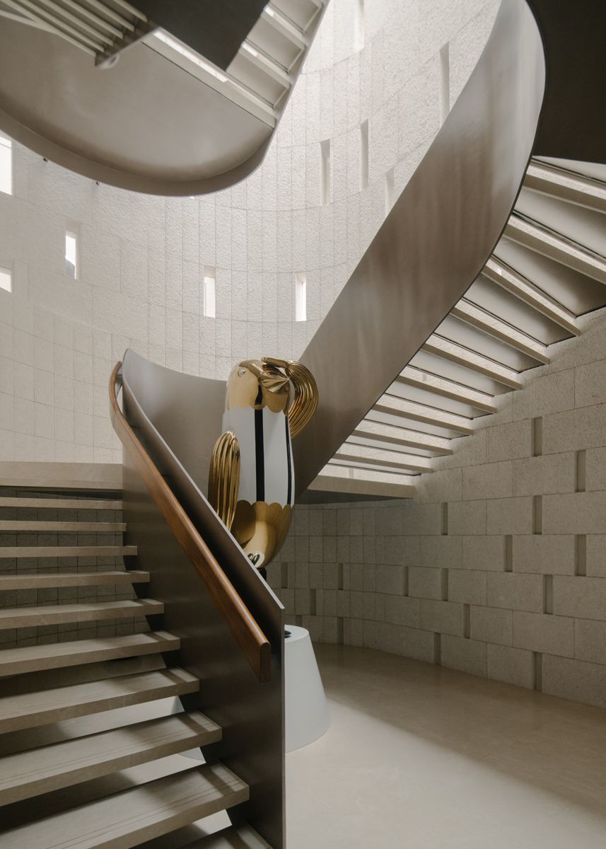 A majestic bird statue precedes over the staircase