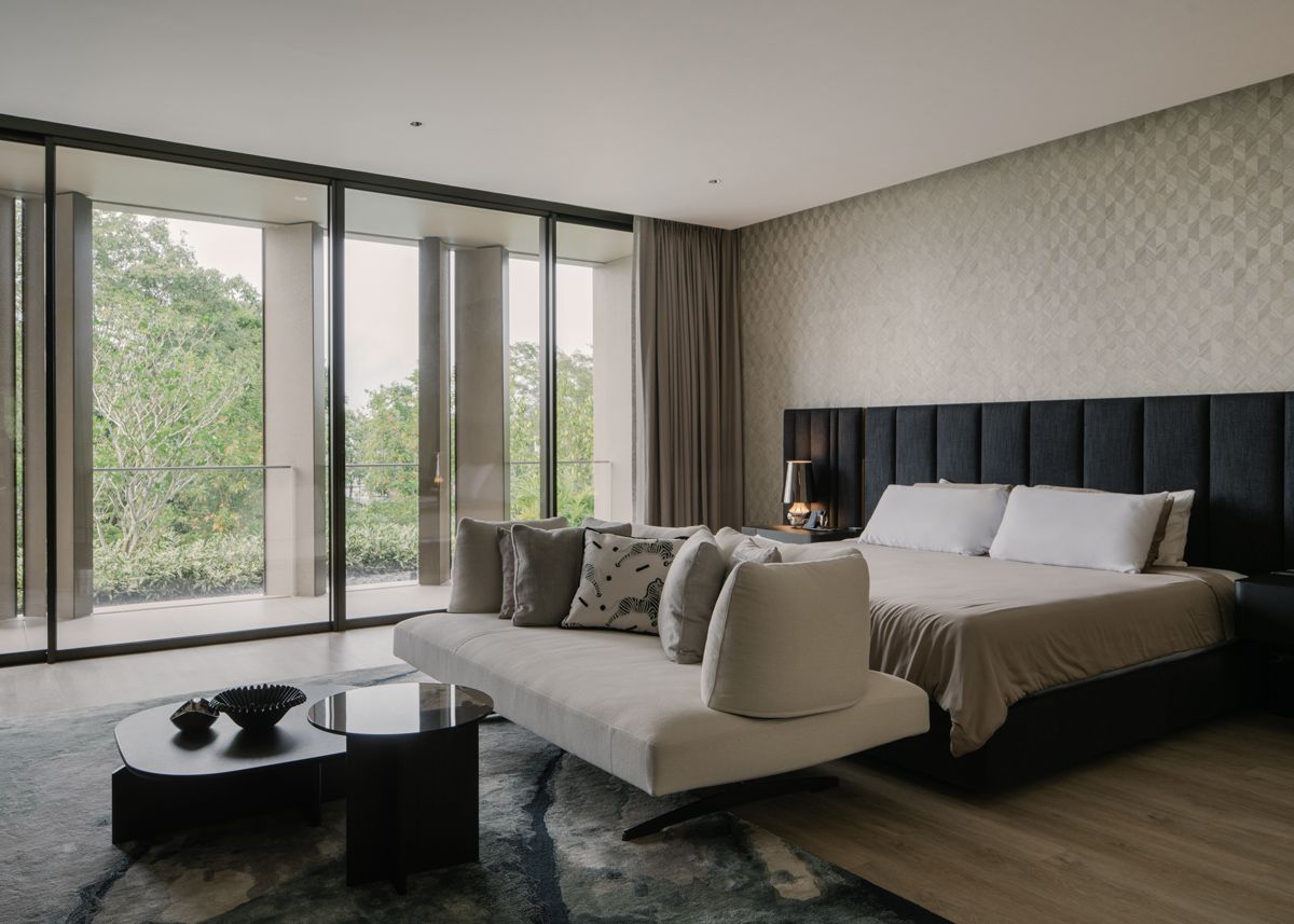 Views of the natural landscape add colour and life to the sleek junior master bedroom