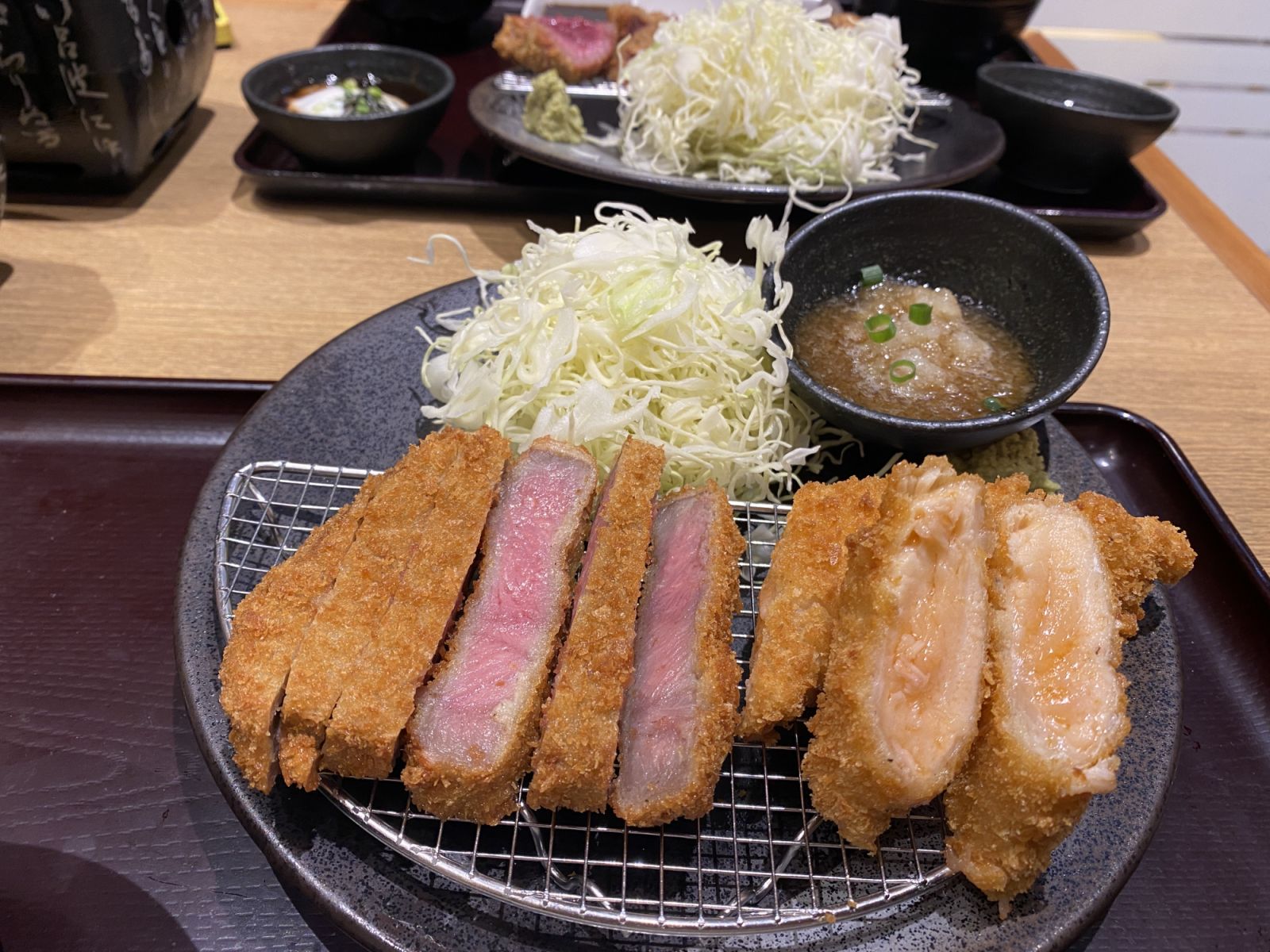 Deep-fried beef and salmon cutlets served rare and diners may cook them to their preferred doneness