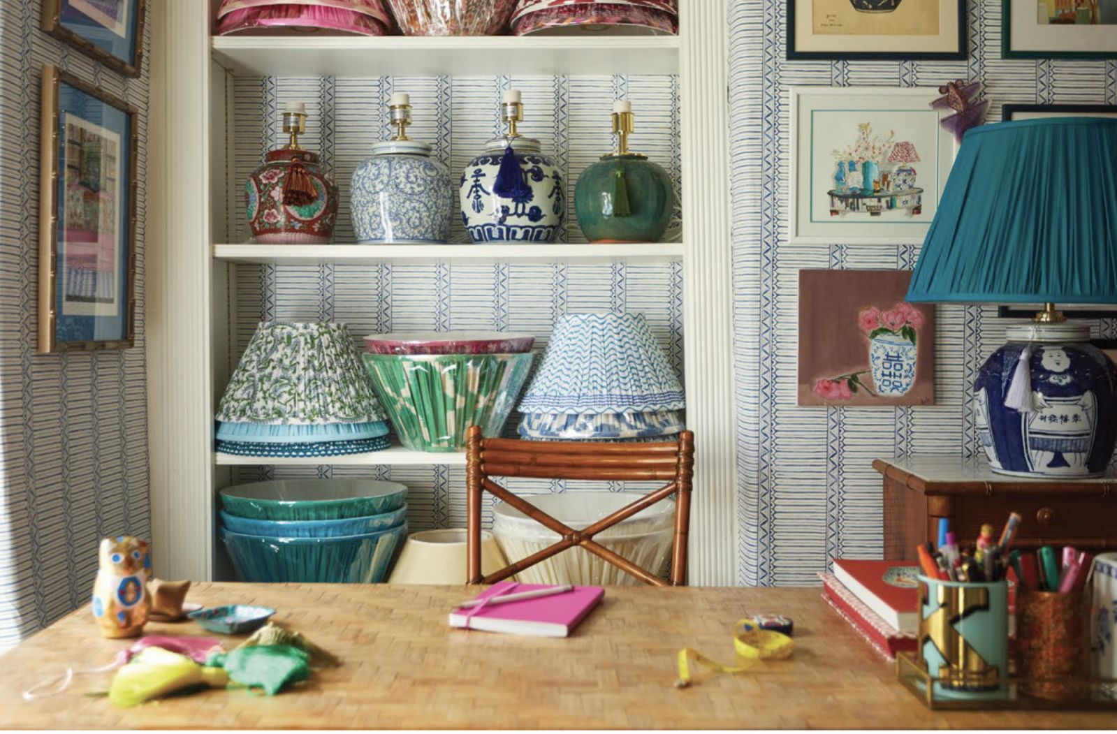 Kate Sbuttoni's lamp room with Domiers wallpaper by Nina Campbell, antique cane chair and desk, lamps from a collection by The
Ginger Jar Lamp Co