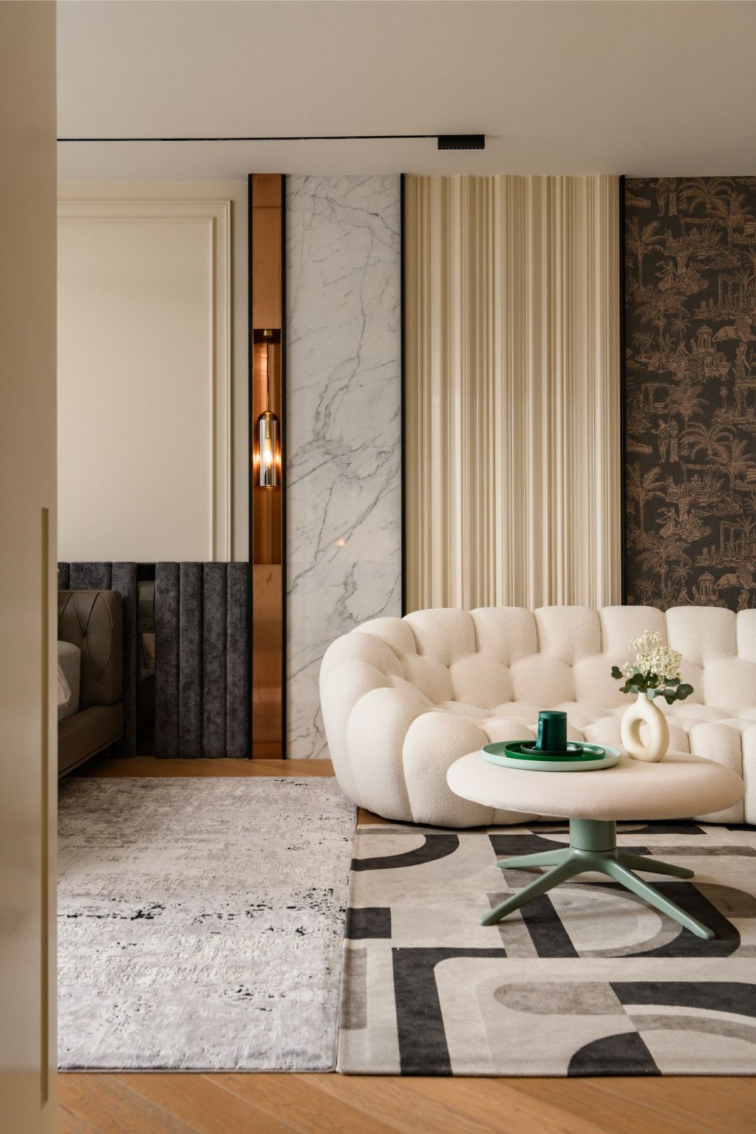 Living room featuring marble, copper accents and cloud-like Roche Bobois seating in this 5,500-square-foot Kuala Lumpur residence