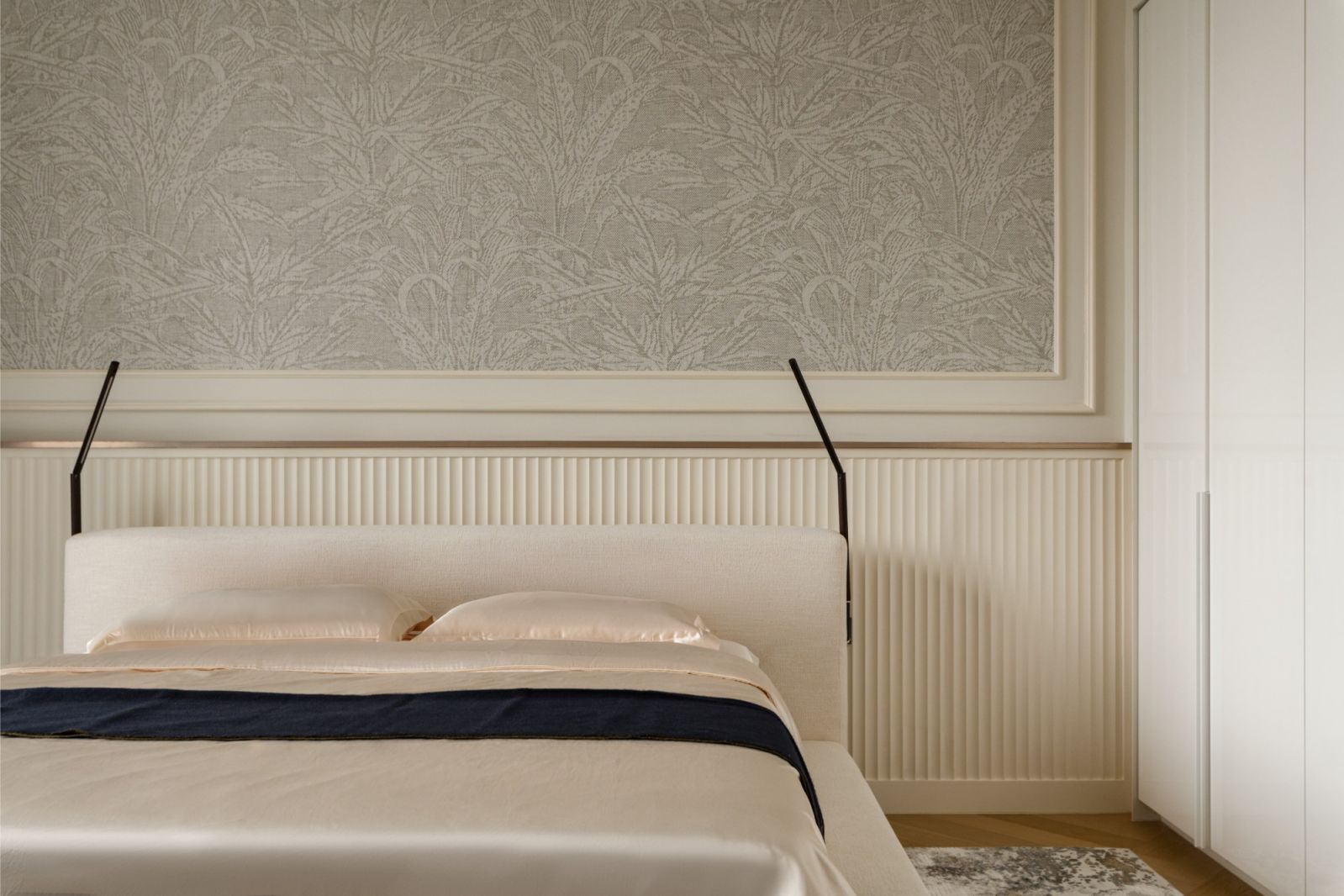 Minimalist master bedroom featuring textured panels and fluted wainscoting in this Damansara Heights penthouse by Solid Design Studio