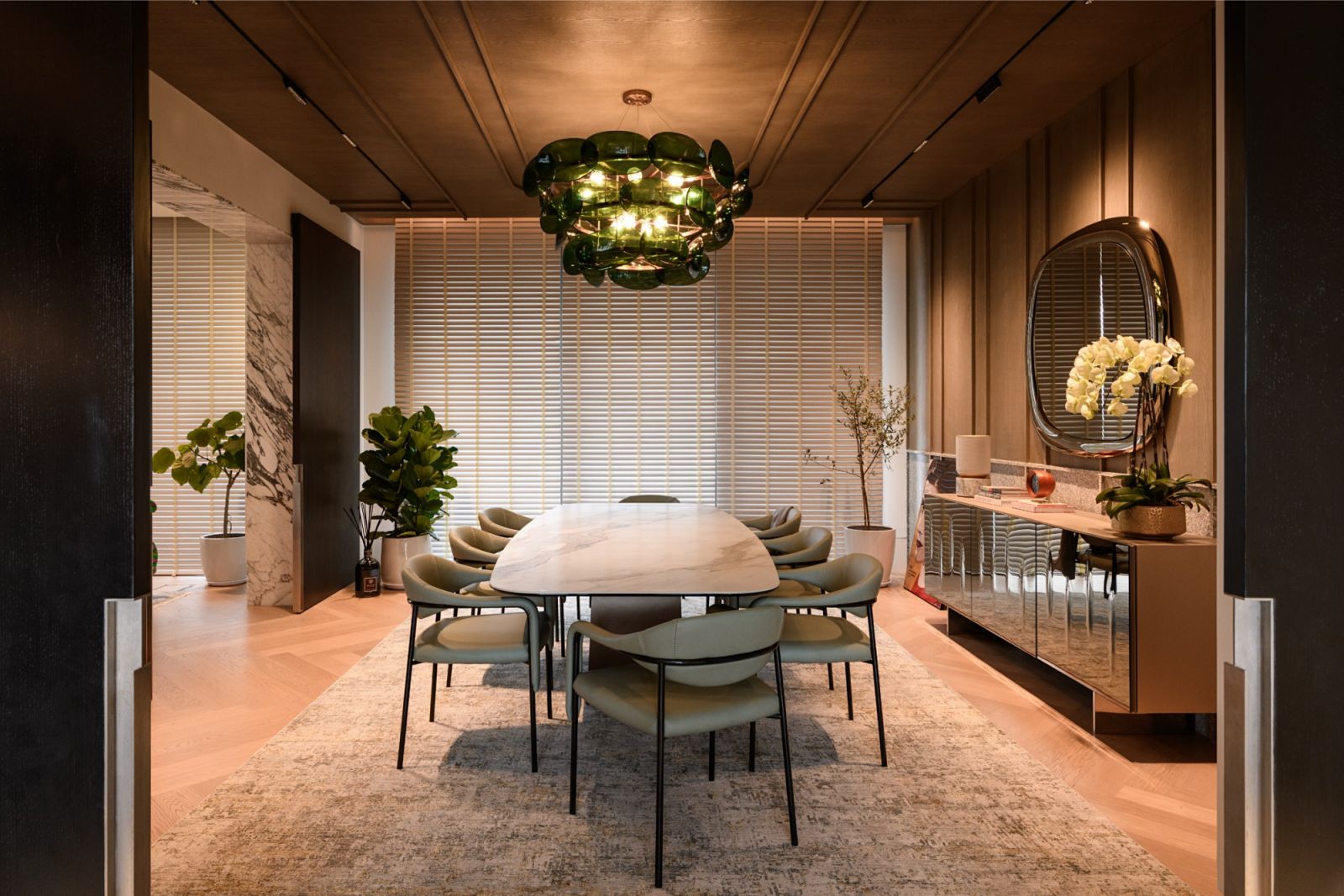 Wider view of the dining area showcasing mirrored console, marble accents and wood panelling details in this Japanese family’s Kuala Lumpur residence.