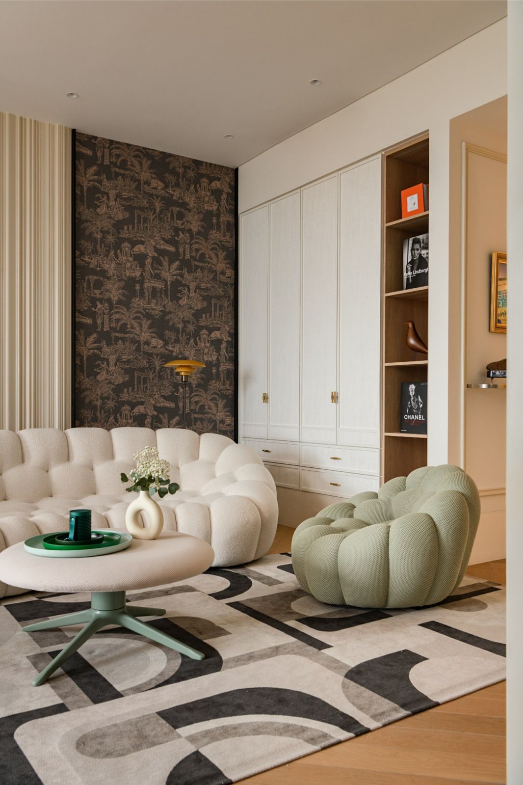 Designer living space with palm-motif Arte wallpaper and curated furniture pieces in this Japanese family penthouse