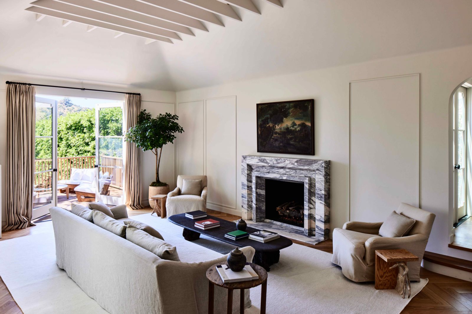 The light-filled living room with a marble fireplace