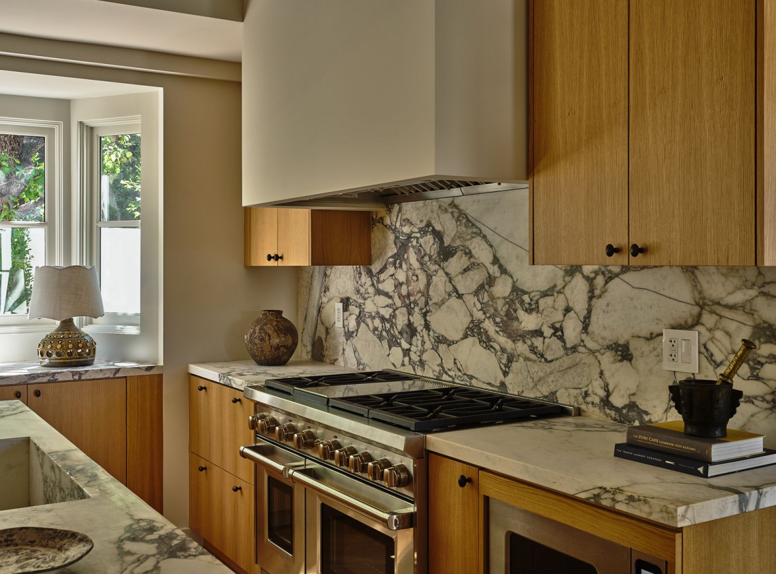 Sophisticated accents of white and grey marble, and rift oak cabinetry (Photo: Michael Clifford)