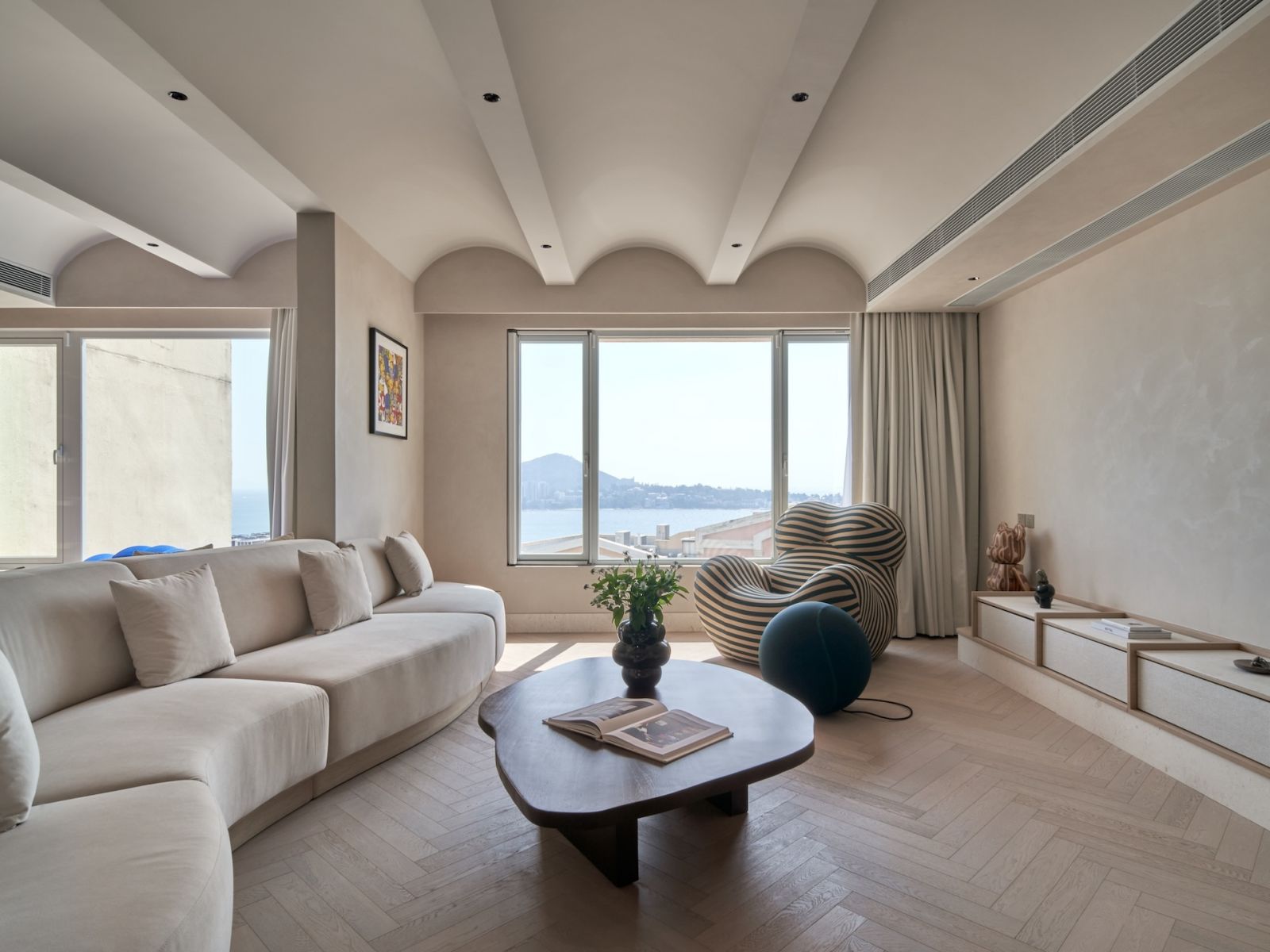 A sculptural live edge coffee table by Dalisay Collection overlooking the Hong Kong sea