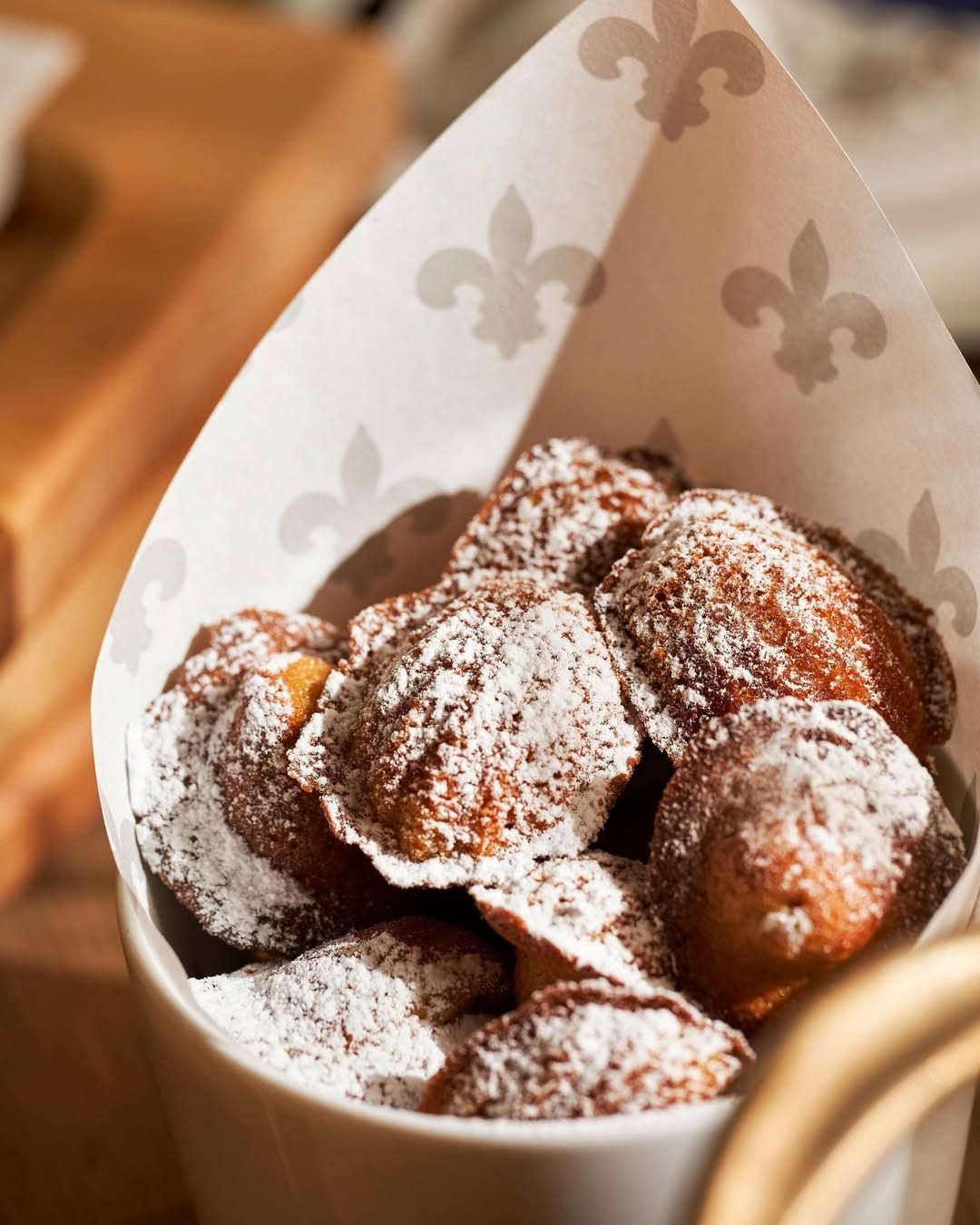 The classic madeleines dusted with powdered sugar at Maison Boulud (Photo: Instagram/@maisonboulud)