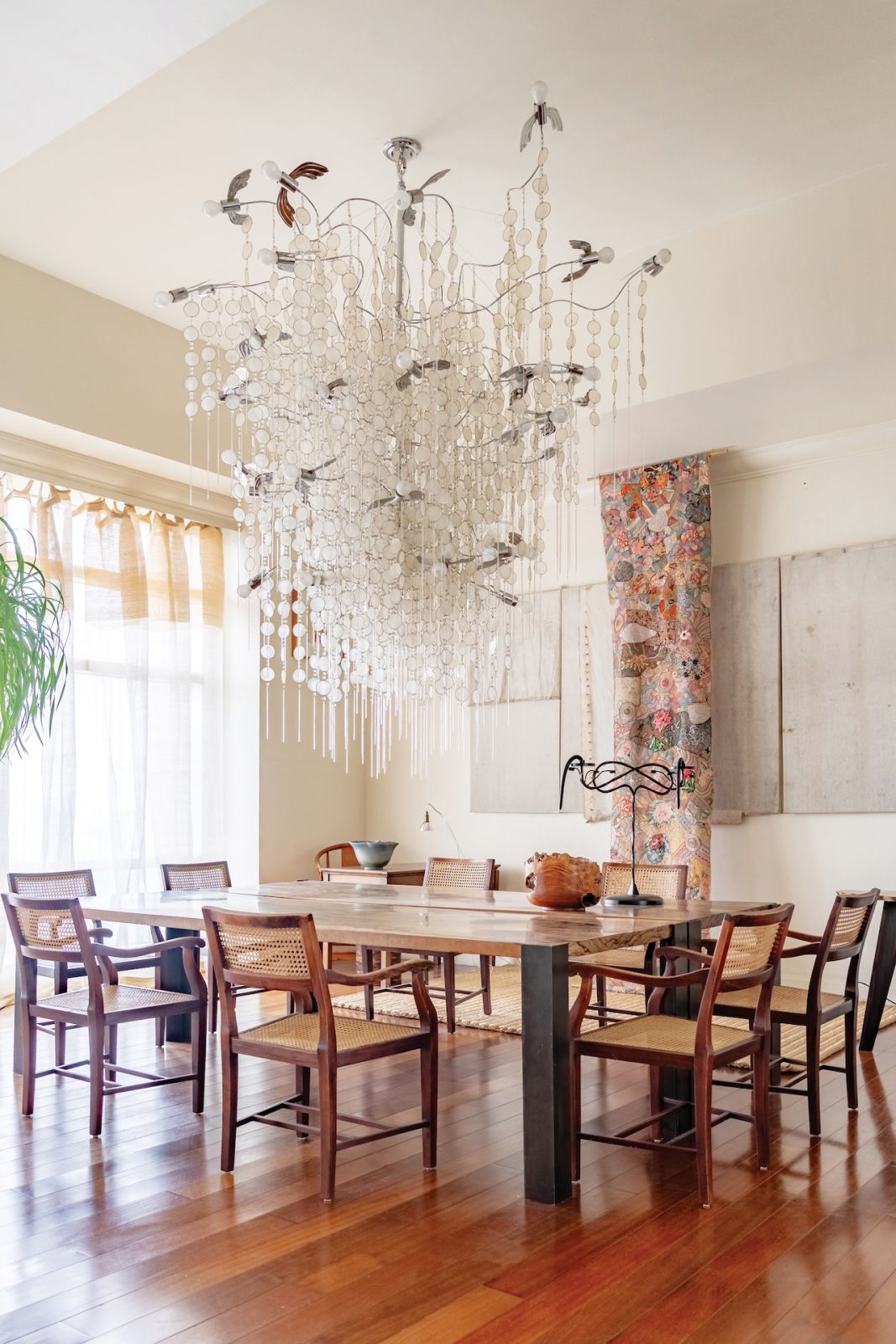 A spectacular chandelier above handcrafted tables, all by SouMak