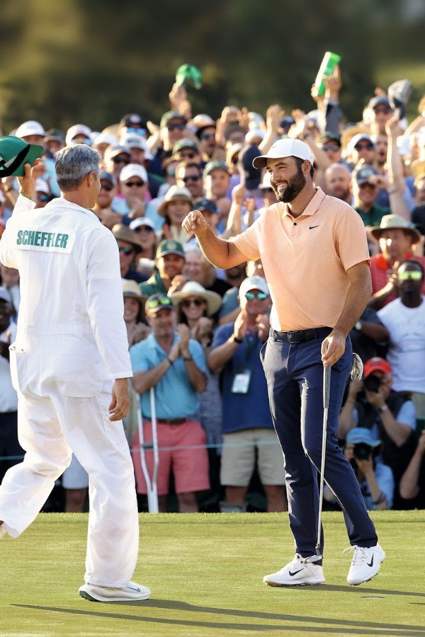 Rolex Testimonee Scottie Scheffler celebrates with his caddie after claiming victory at the 2024 Masters Tournament