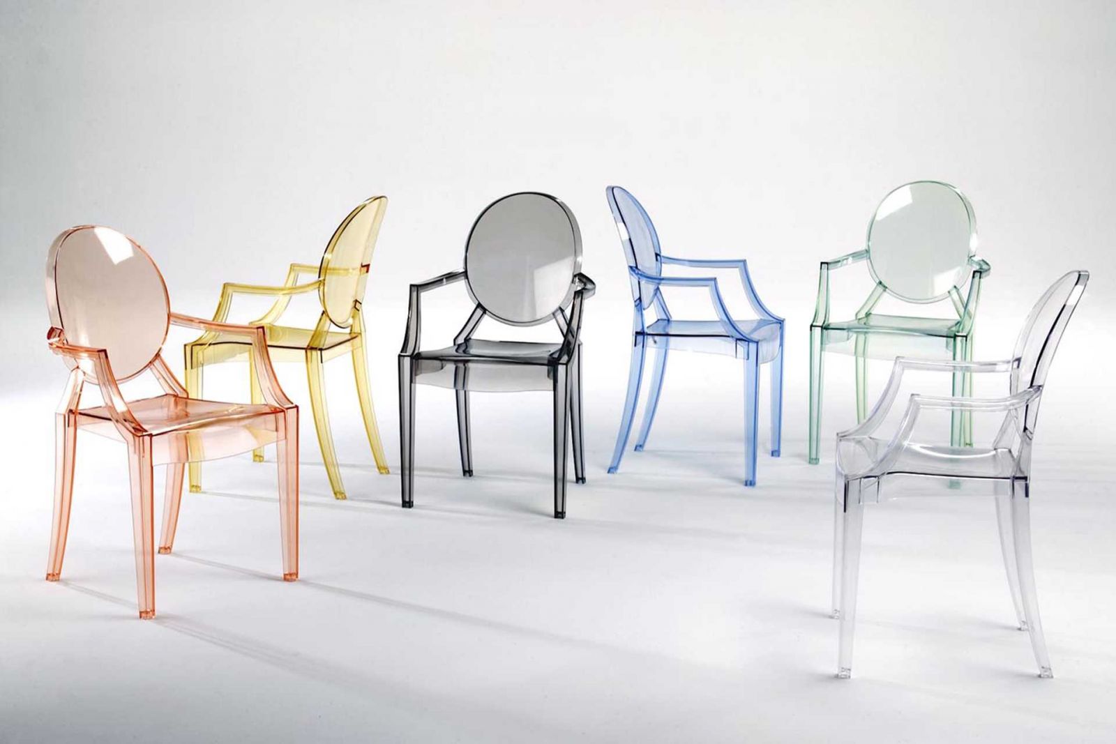 A rainbow of transparent Philippe Starck Louis Ghost armchairs, including pink, yellow, black, blue, green and clear versions, showcasing versatile modern dining chair options for contemporary interiors (Photo: Kartell)
