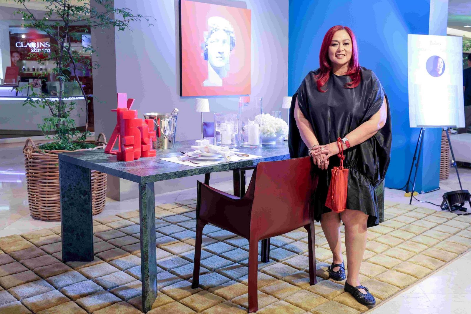 Cecil Ravelas, pictured with her vignette for Rustan's Designer's Circle 2025, is the principal of Red Interior Design and a seasoned interior designer and project manager with over 30 years of experience. A pioneering graduate of the consortium program between the Philippine School of Interior Design and De La Salle–College of Saint Benilde, she further refined her craft at Istituto Marangoni in Milan. A recent notable project is the Manuel Roxas Room at the Laperal Mansion.