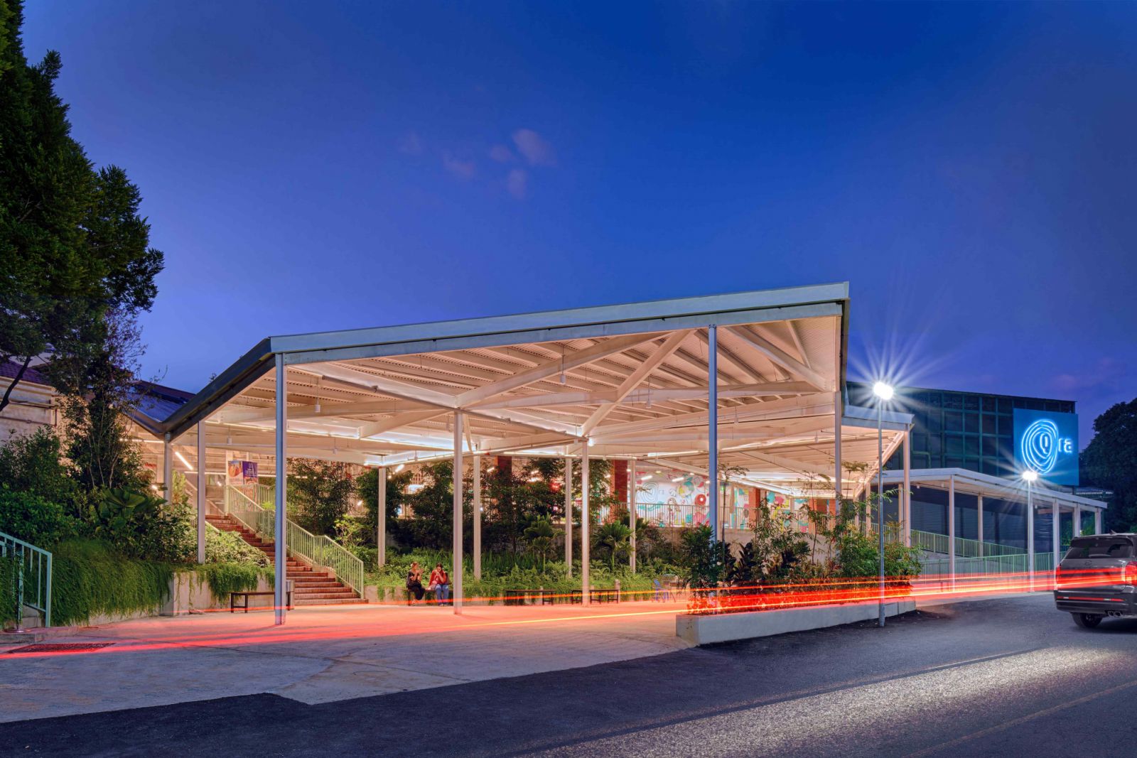 The folding roof canopies create sheltered yet porous drop-off points