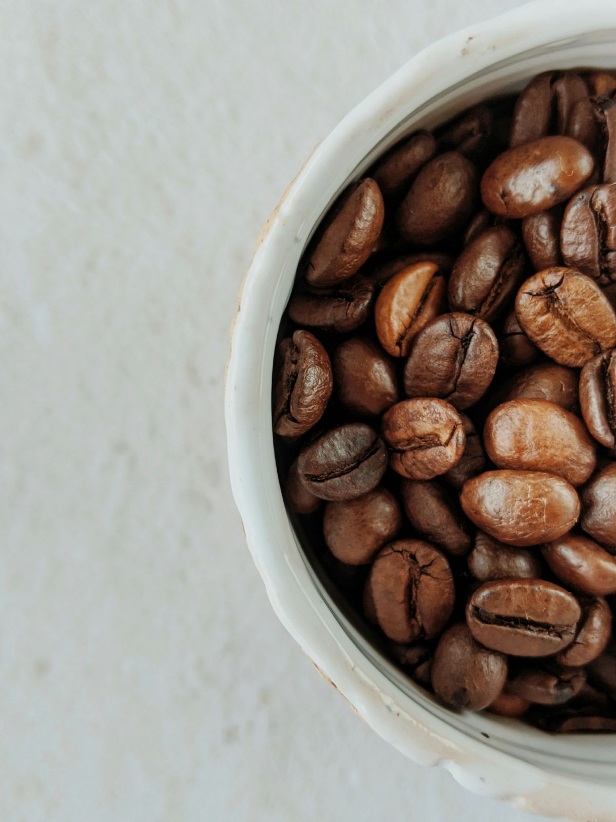 A cup of coffee beans (Photo: Alin Luna/Unsplash)