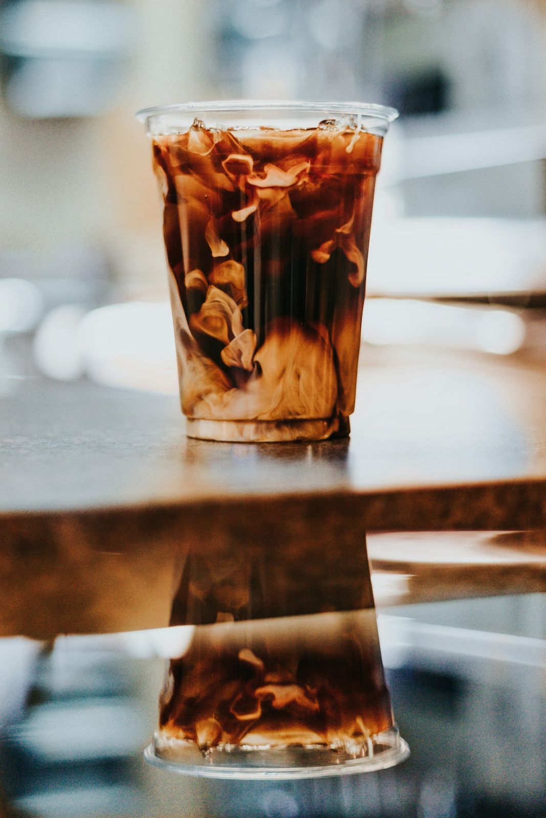 A to-go up of coffee with a dash of milk (Photo: Andrew Valdivia/Unsplash)
