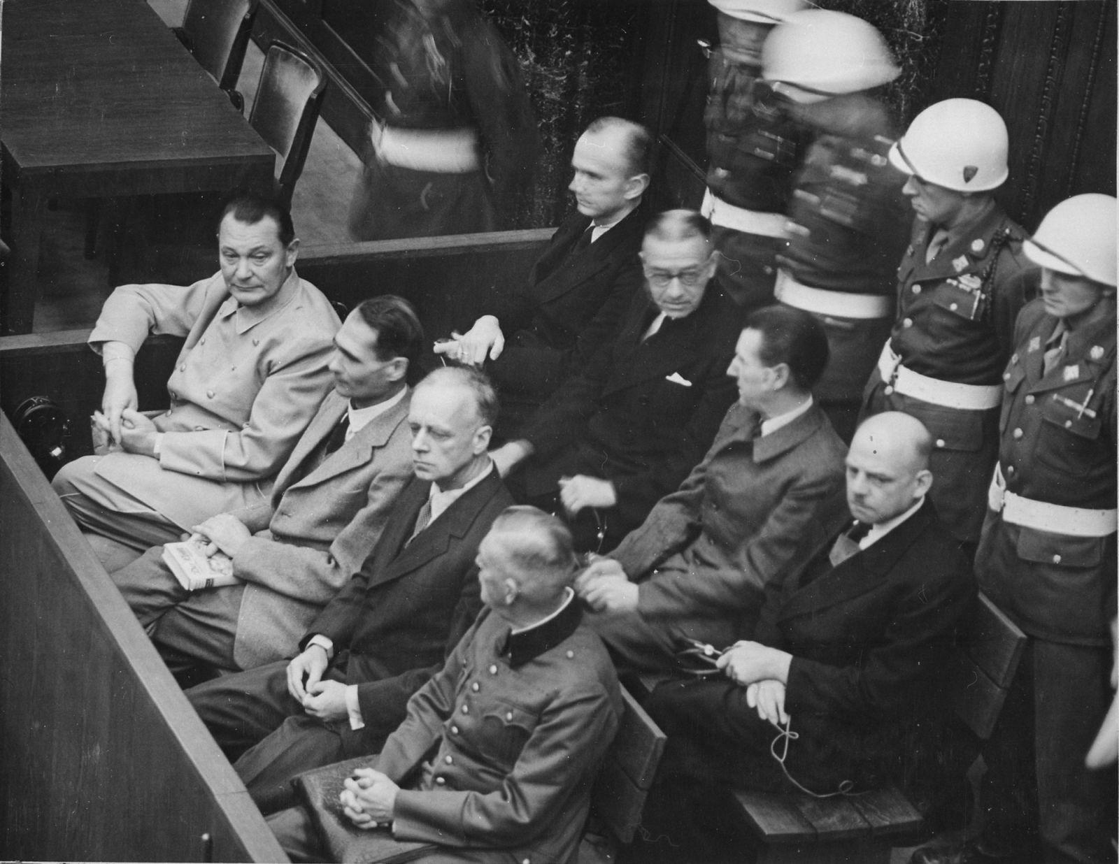 Front row, left to right: Nazi officers like Hermann Göring, Rudolf Heß, and Joachim von Ribbentrop at the Nuremberg trials (Photo: WikiCommons)