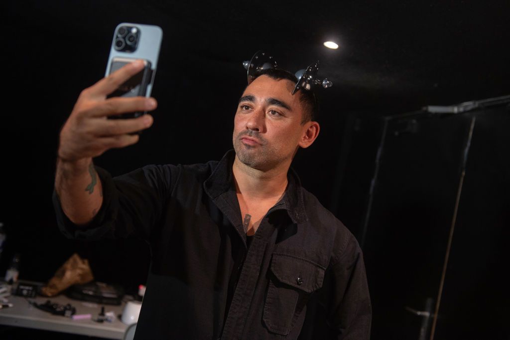 PARIS, FRANCE - SEPTEMBER 24: Director and fashion editor Nicola Formichetti is seen taking a selfie wearing hear wear from the collection, backstage after the Anrealage Womenswear Spring-Summer 2025 show as part of Paris Fashion Week on September 24, 2024 in Paris, France. (Photo by Kay-Paris Fernandes/Getty Images)