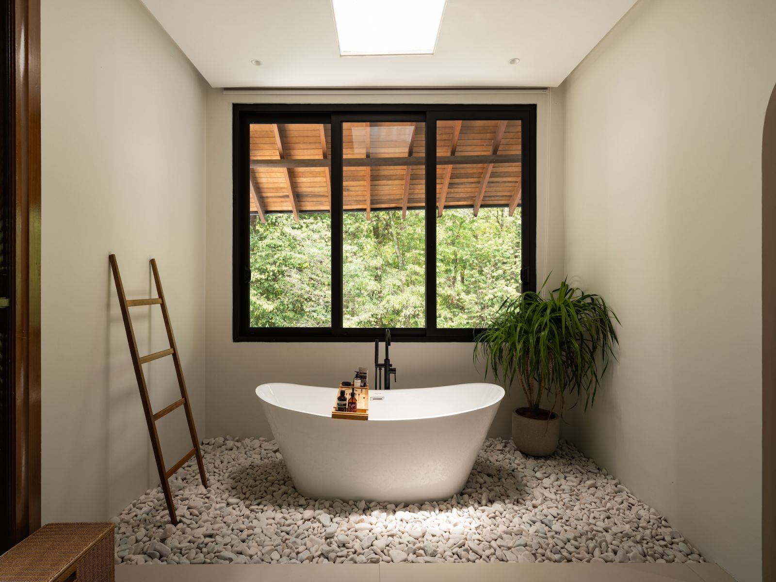 The master bathroom continues the home’s organic aesthetic with textural richness and natural materials