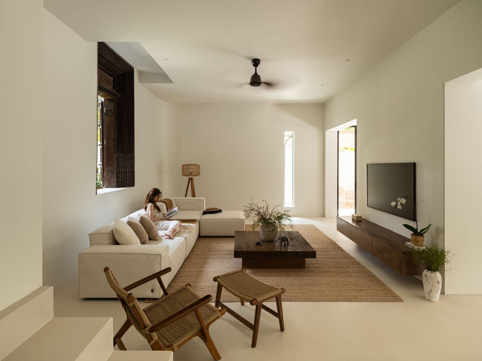 Sunlight floods through expansive openings in this seamlessly connected living space