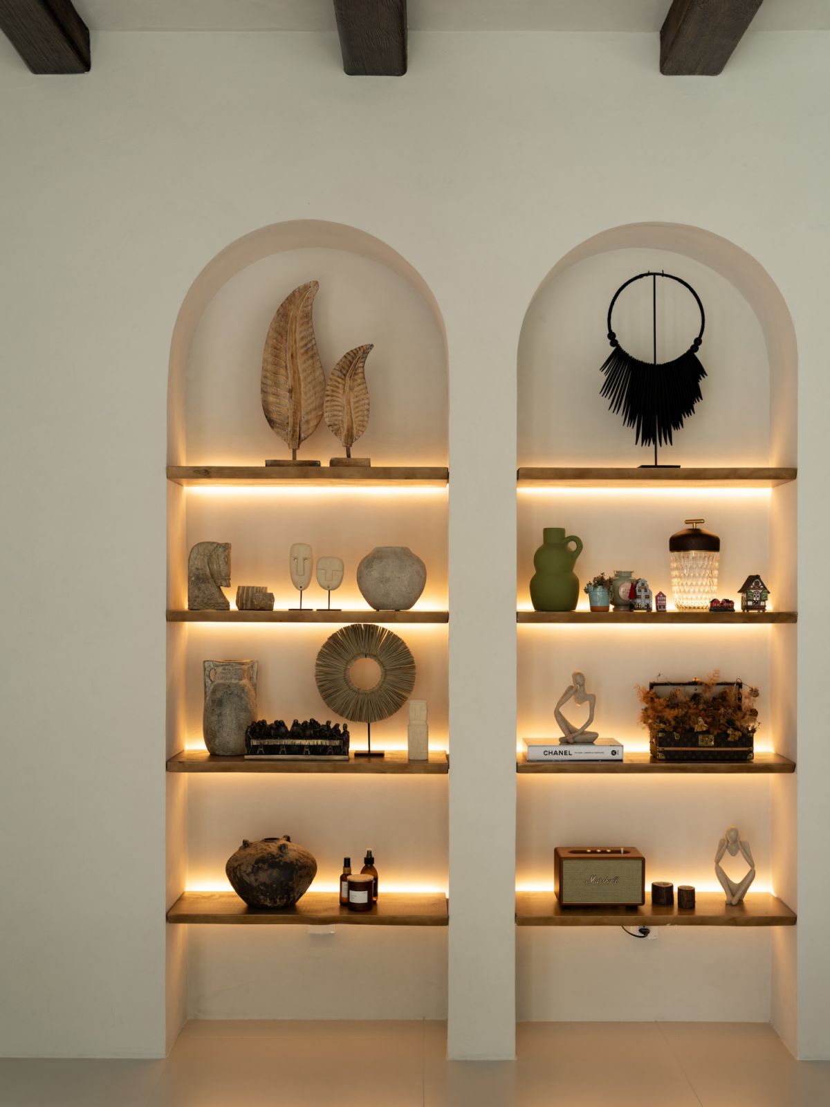 Timber shelving showcases the homeowners’ carefully curated collection of Balinese artefacts and personal treasures