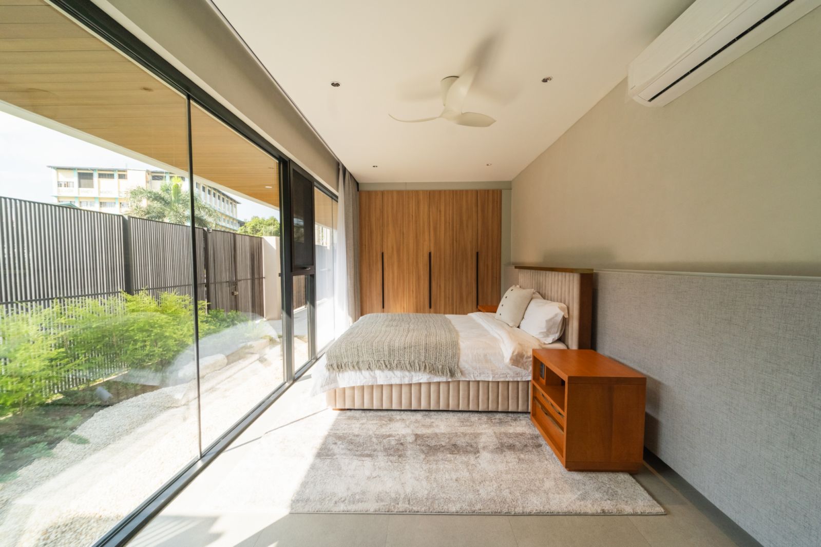 A bedroom overlooking the main garden at a family home in Malabon, Manila