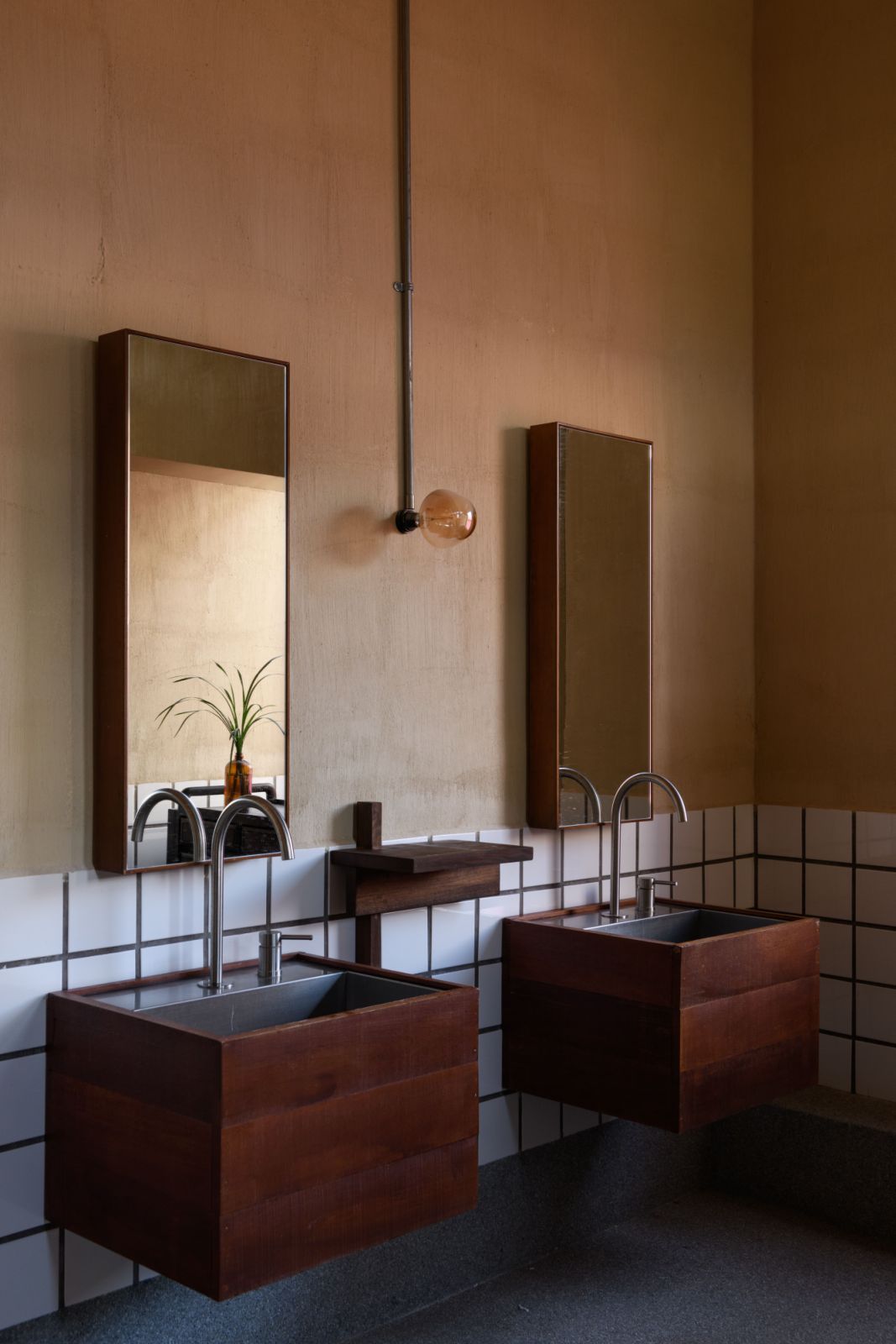 Custom fixtures and carefully preserved architectural elements ensure that even utilitarian spaces within this transformed George Town landmark contribute to the cohesive design narrative