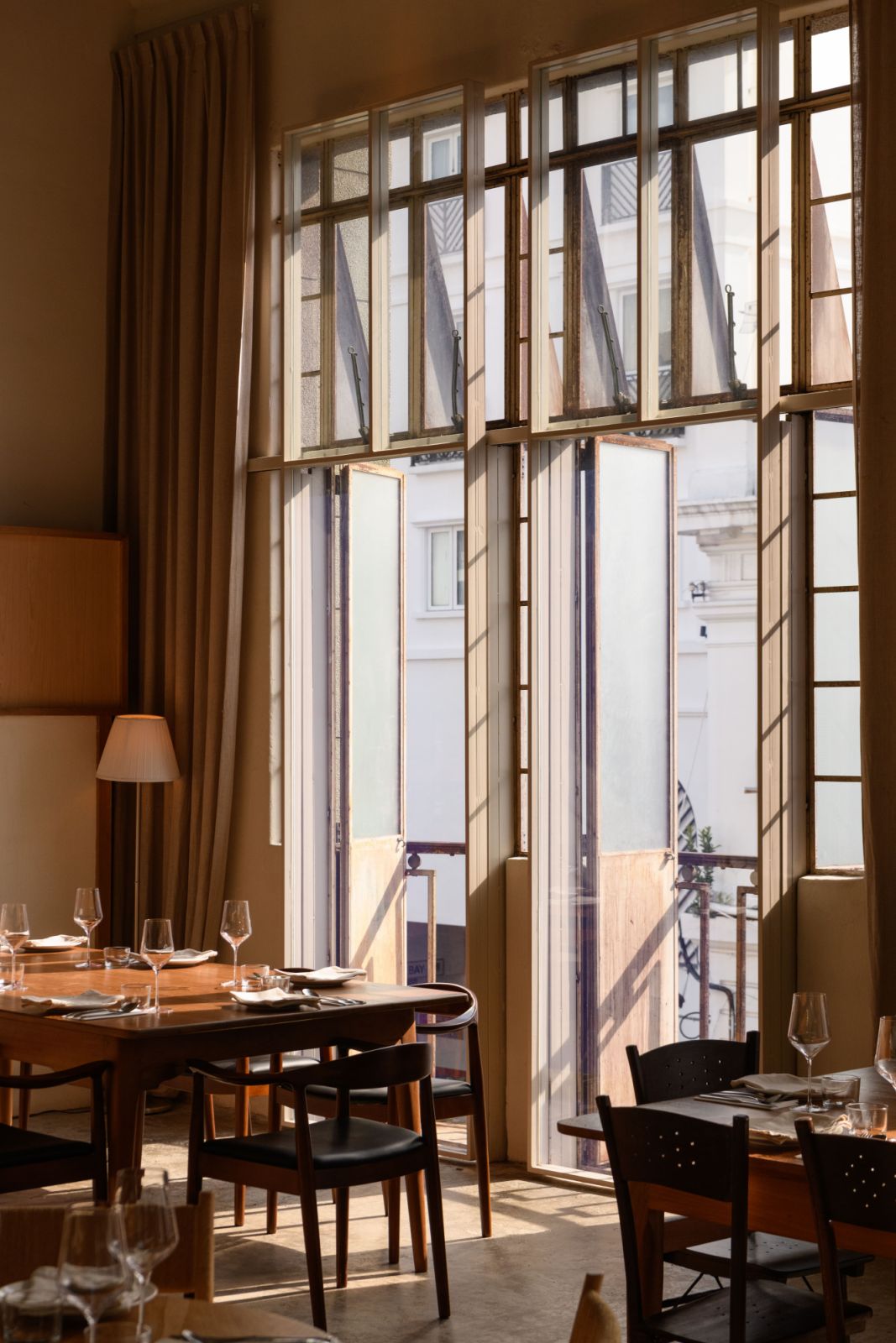 The original Art Deco window framework has been carefully preserved while introducing warm wooden furnishings