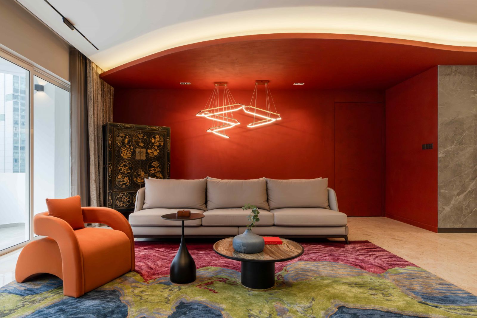 A textured feature wall in bold red accent anchors the living space