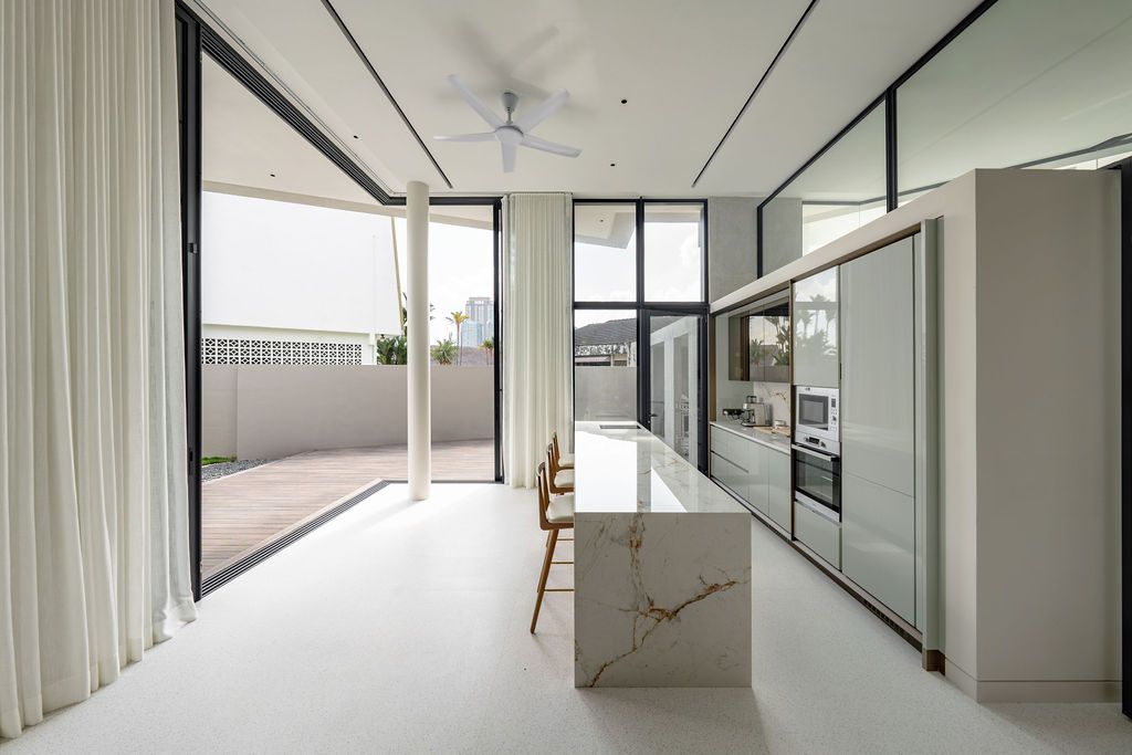 The BOFI kitchen features a striking marble island that contrasts with the minimal white cabinetry