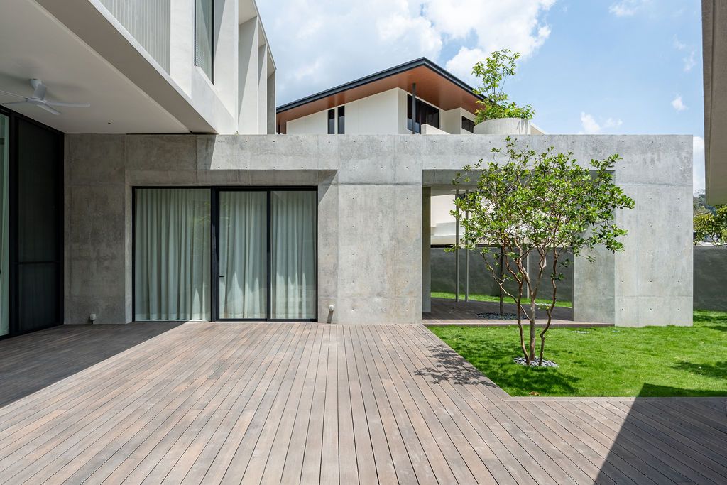 The expansive timber deck opens onto one of the triangulated garden spaces created by the cruciform layout