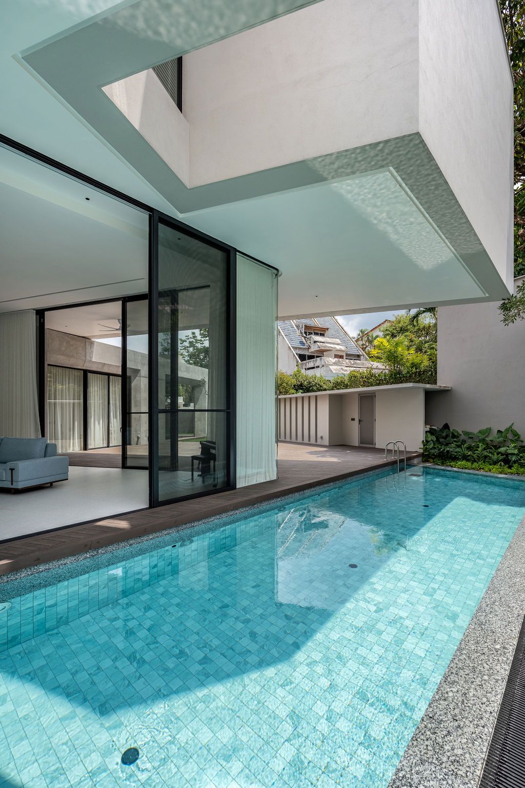 The swimming pool extends along one arm of the cruciform layout, creating four triangulated external pocket spaces