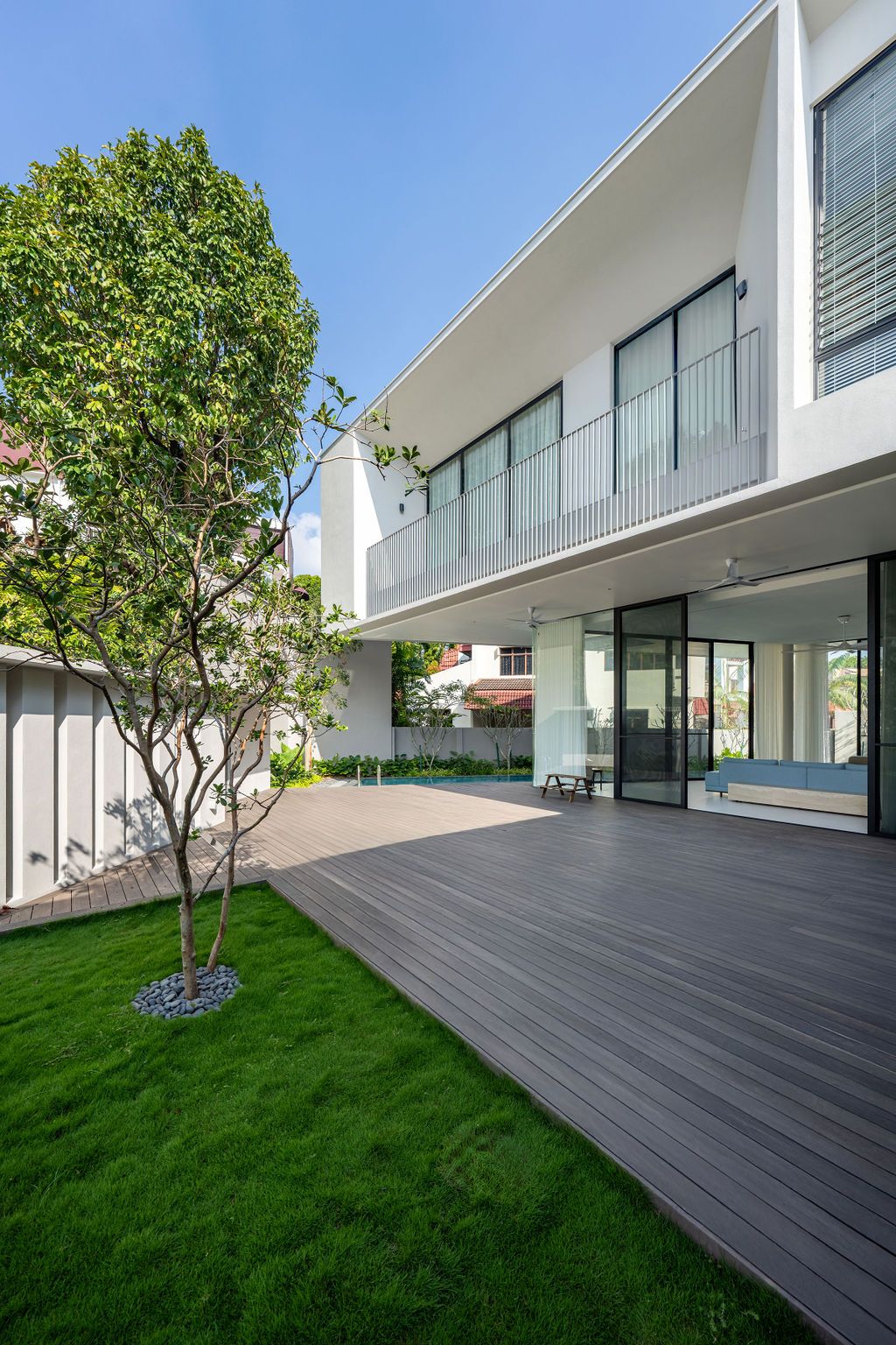 The entrance sequence showcases the strong structural blade walls expressed in fair-faced concrete