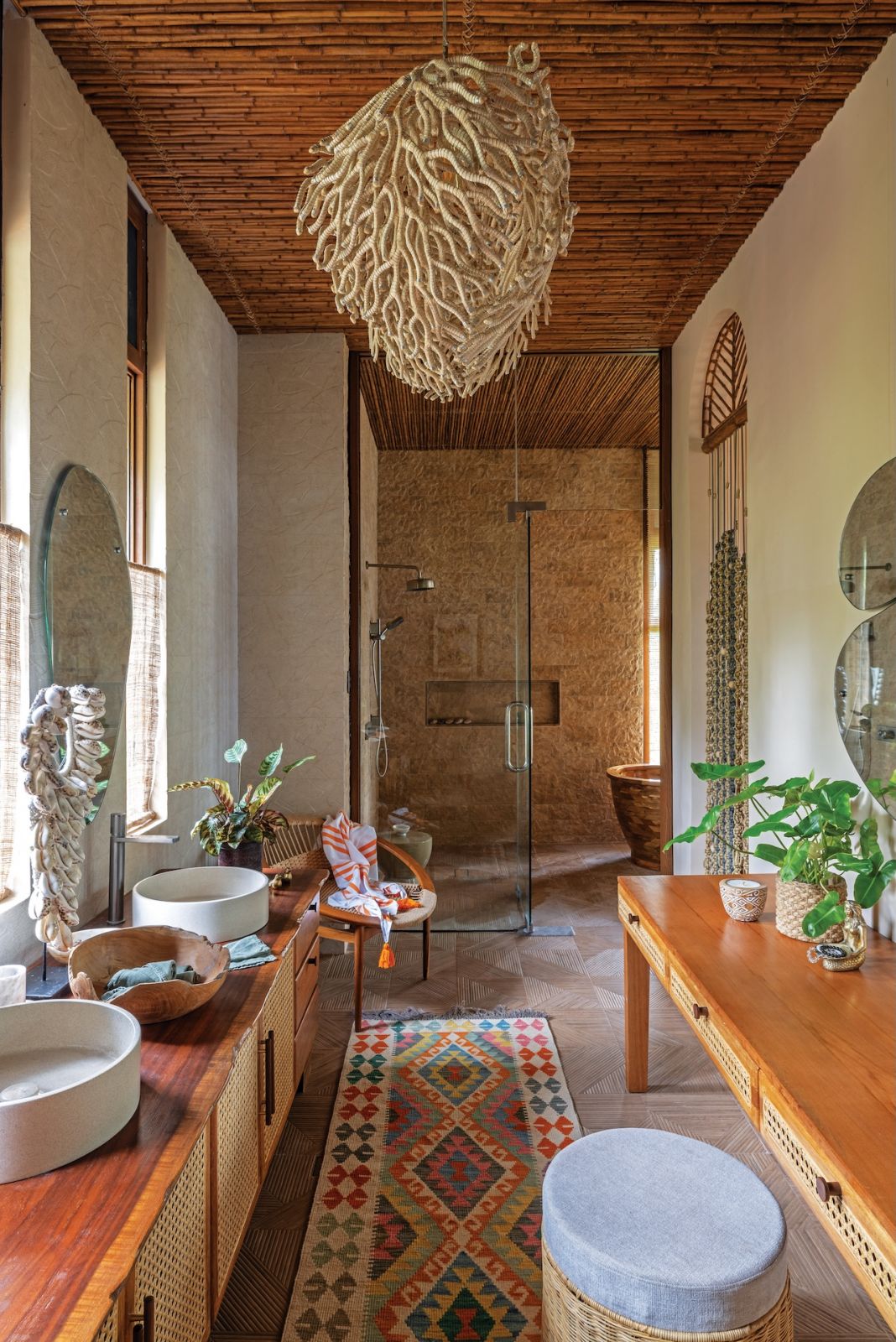 A chandelier by T’nalak Home serves as the main highlight of this light and airy bathroom at Aman Sinaya on Mati Island, Mindanao