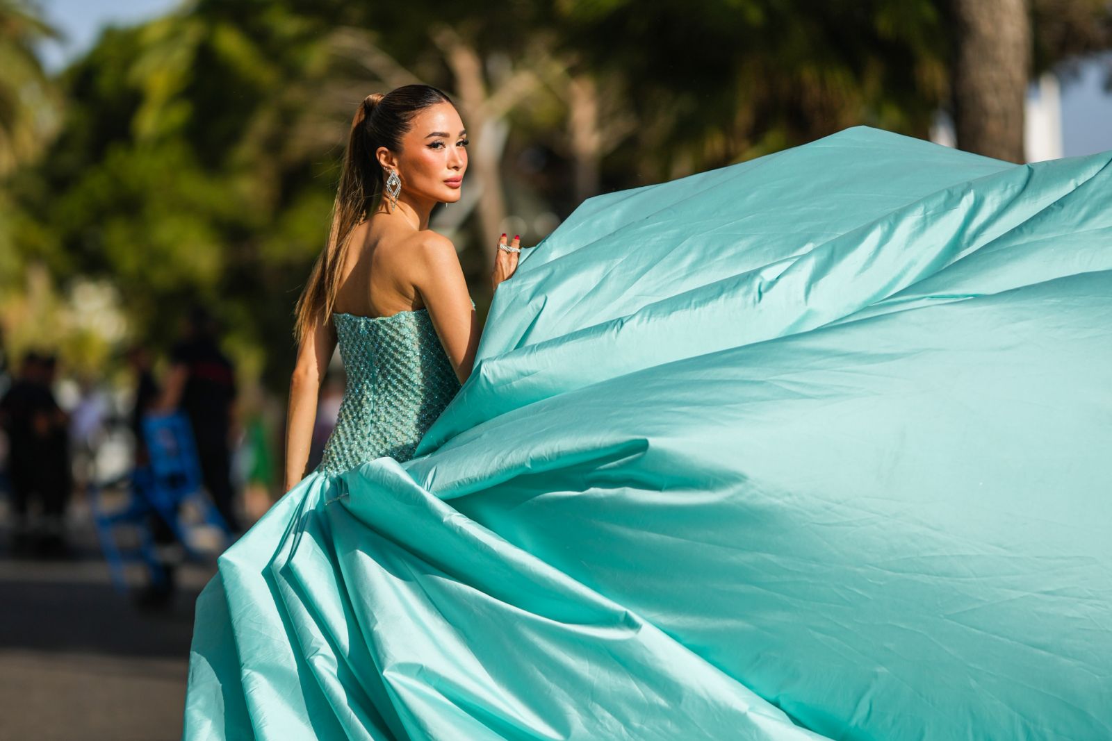 Heart Evangelista wears earrings, a blue turquoise off-shoulder dress with embossed jewels, corset and a long oversized skirt train from Tony Ward (Photo: Edward Berthelot/Getty Images)