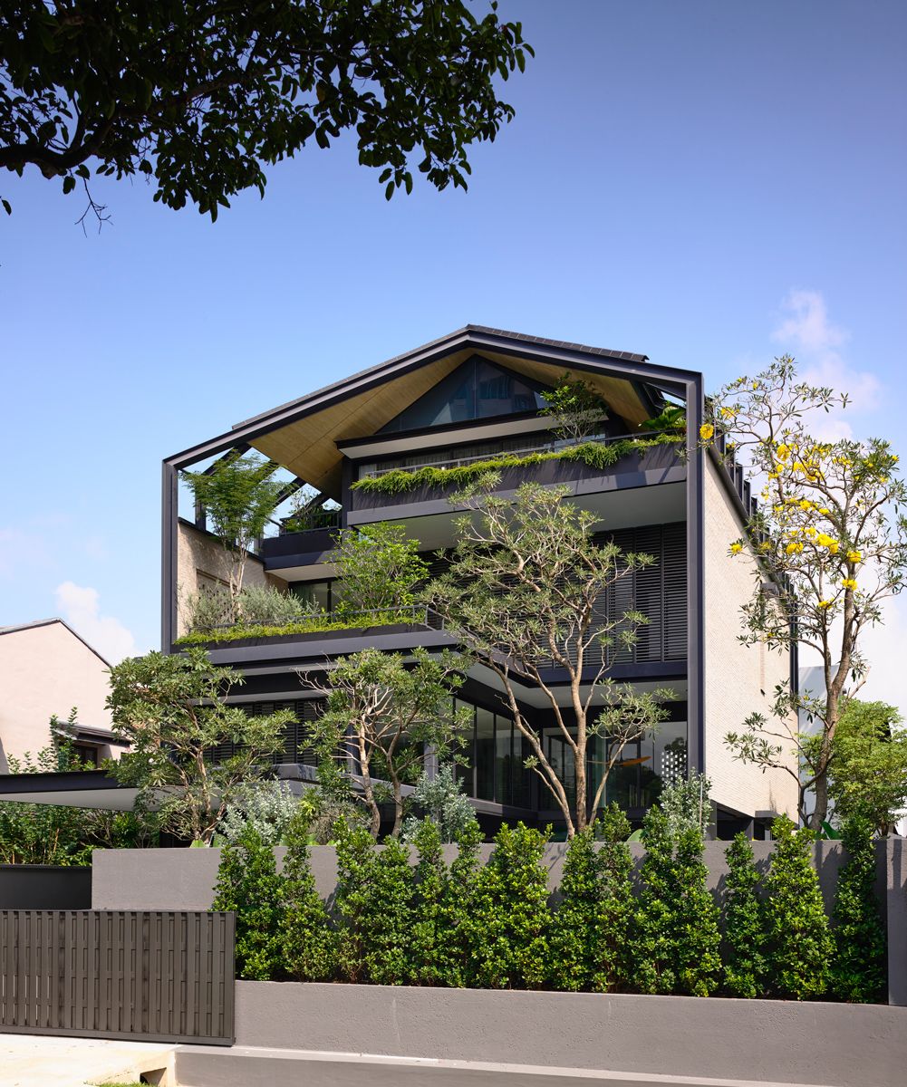 Oblique view of the front elevation reveals the stepped terraces and gabled profile articulated with steel ribs