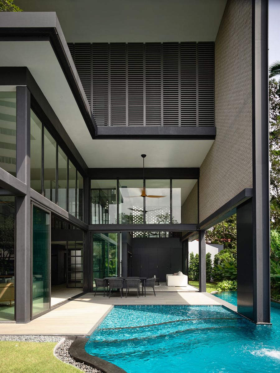 The roof structure shades the terrace and pool, revealing double-volume spaces on both the first and second storeys