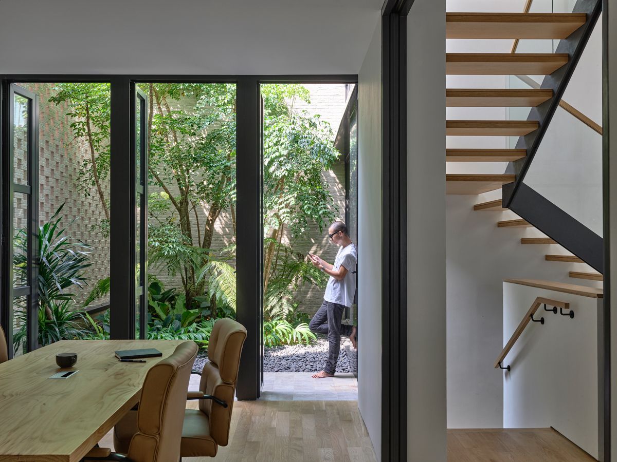 A lush, two-storey rear courtyard brings daylight and ventilation into the heart of the bungalow