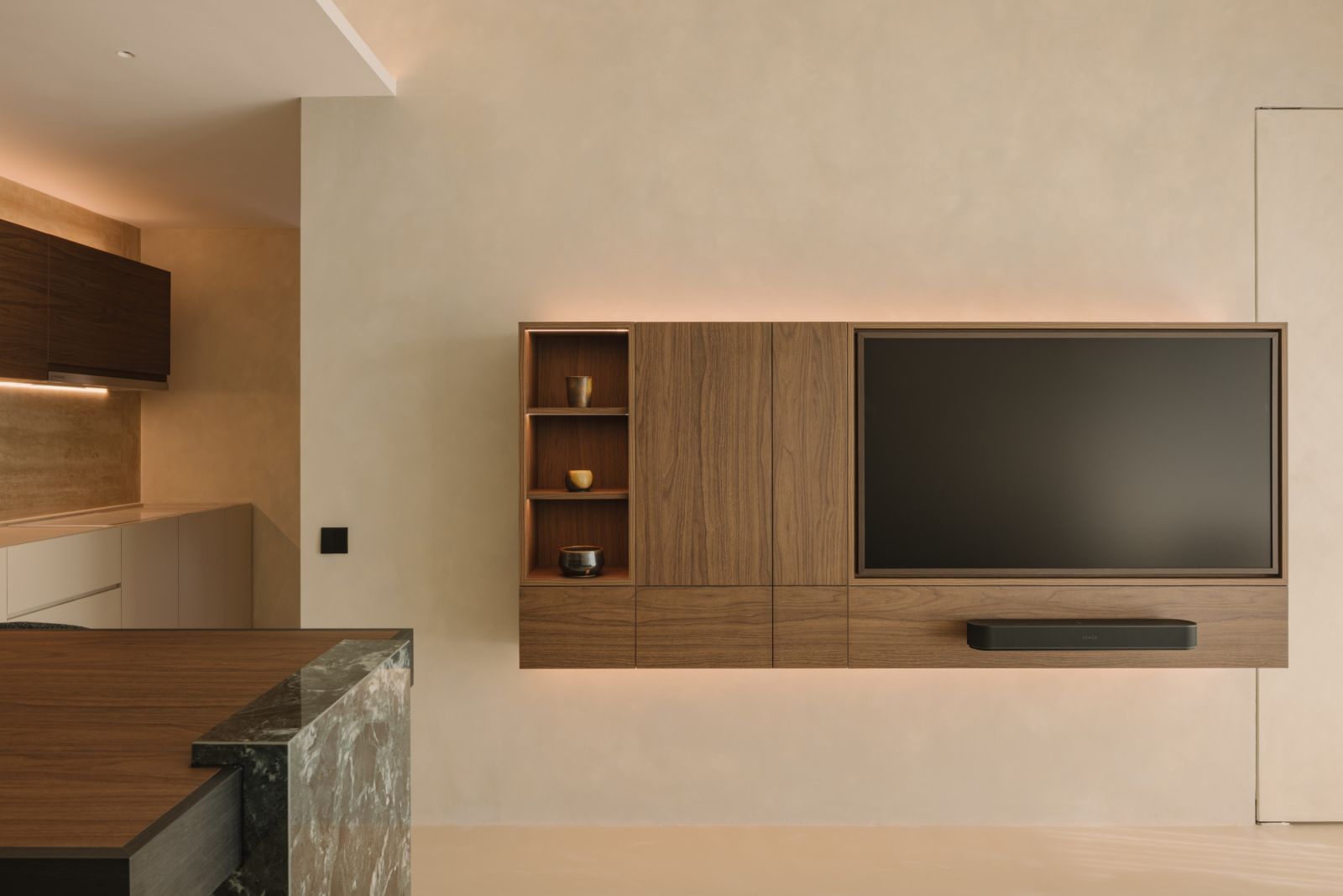 Minimal yet characterful, the floating console offers a quiet moment of tactility with its natural wood grain and softly integrated shelves, while the concealed LED strips create a soft, ambient glow