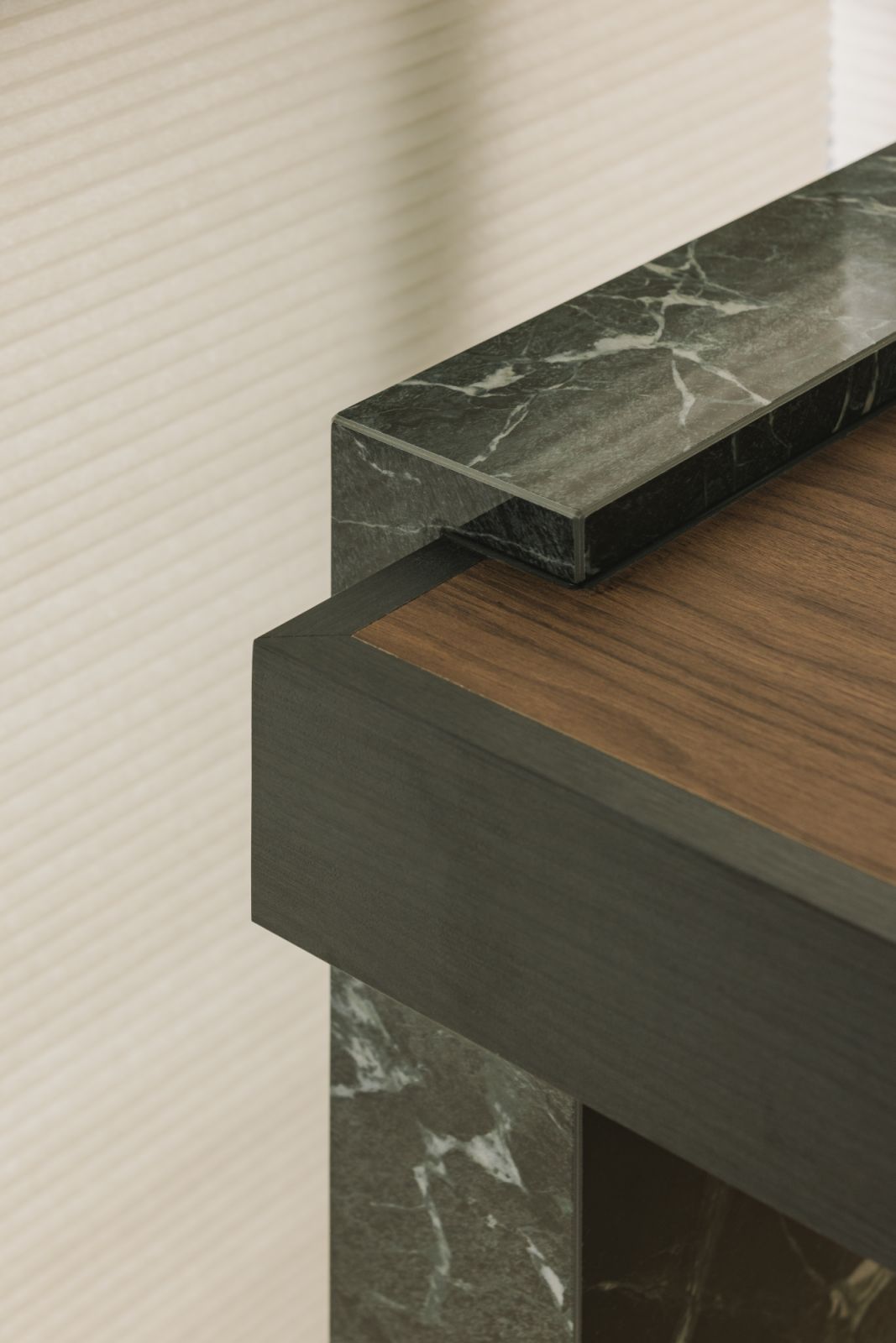 A closer look at the built-in study’s refined material layering: veined marble, blackened wood, and warm walnut in seamless harmony