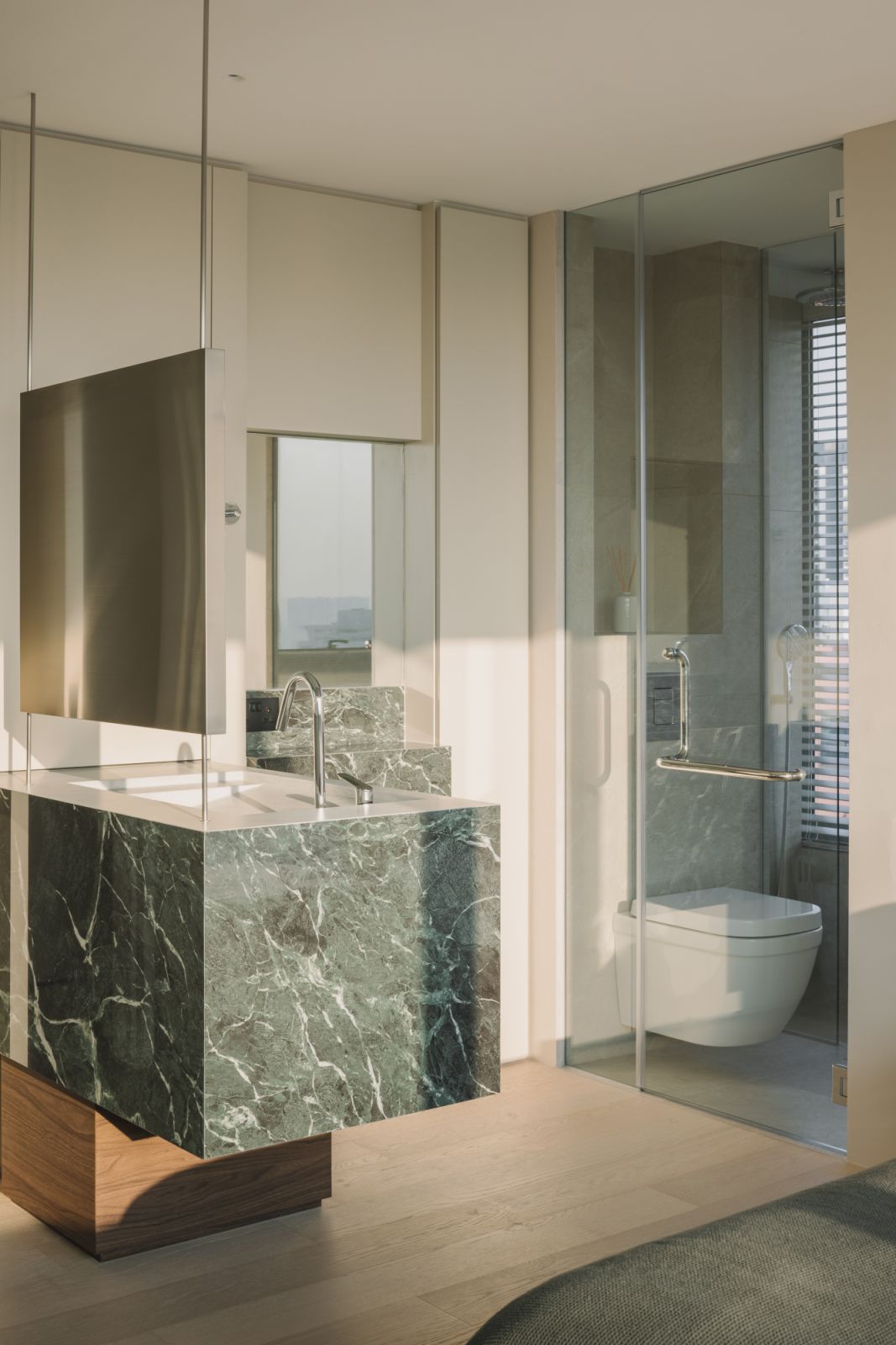 A play of planes and precision: the monolithic basin is elevated by stepped ledges and a refined, minimal tapware selection