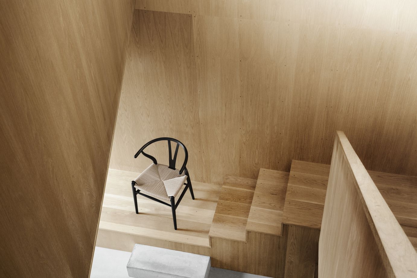 The Wishbone Chair’s sculptural silhouette stands out against natural wood interiors, showcasing its blend of Danish craftsmanship and timeless design (Photo: Carl Hansen & Søn)