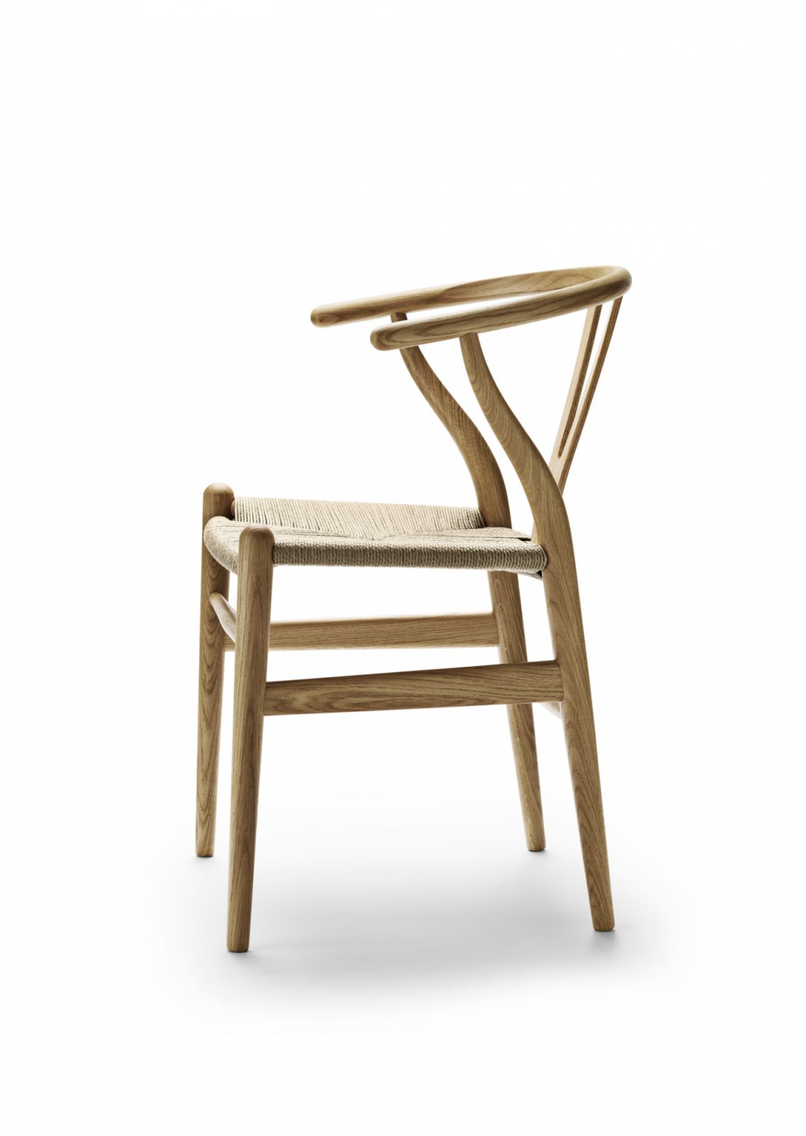 Side view of the Wishbone Chair reveals its signature Y-shaped back and graceful curves—each piece assembled and finished by hand (Photo: Carl Hansen & Søn)