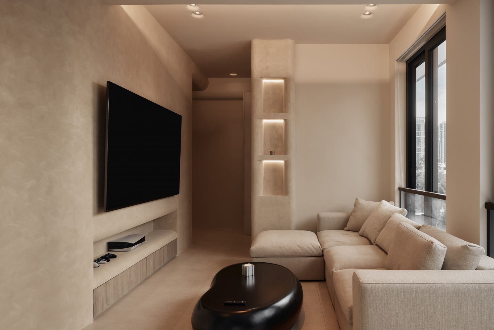 The interplay of plush seating and curved niches creates a warm, cocooning atmosphere that invites relaxation and intimate gatherings