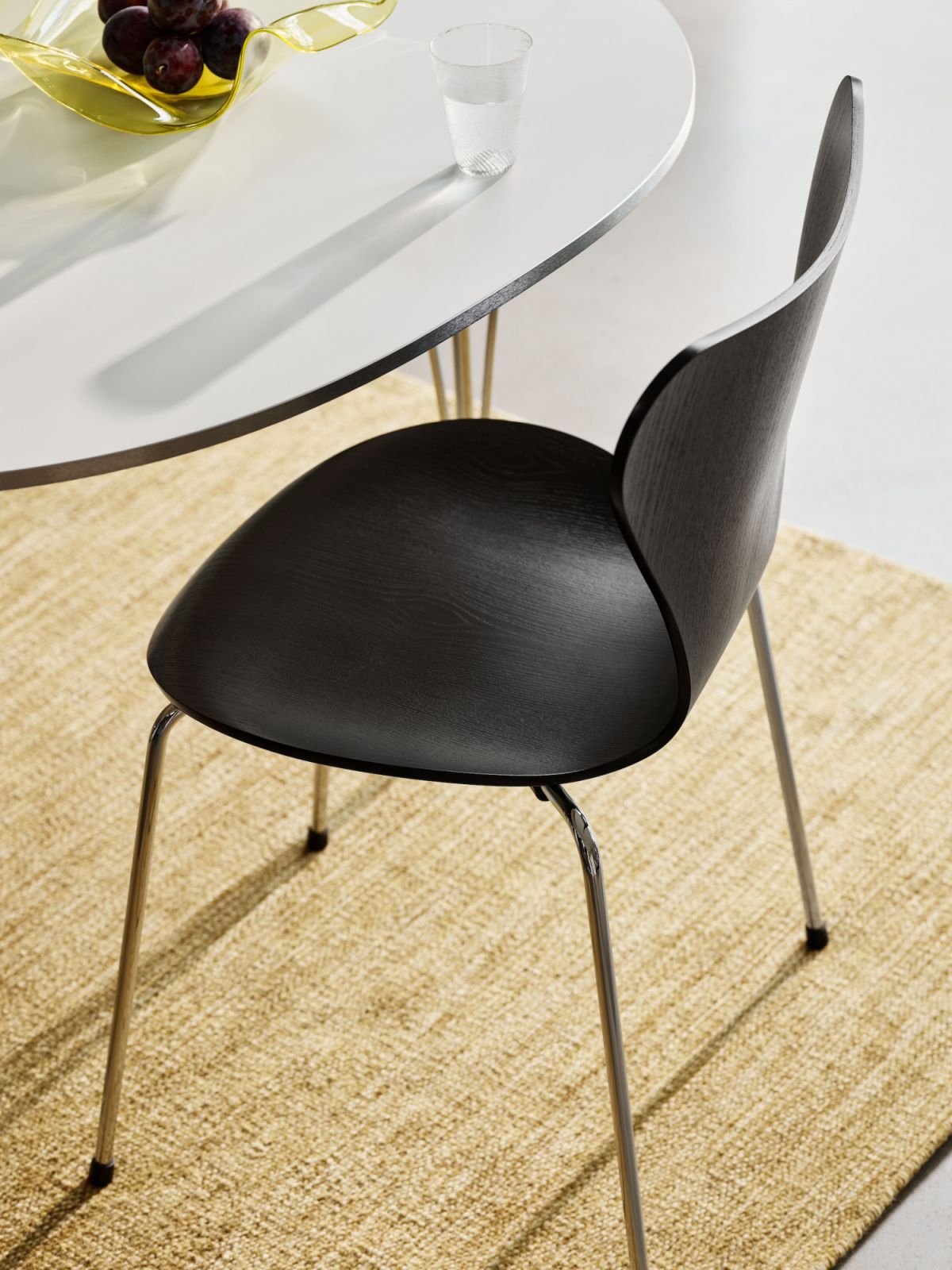 A detailed view of a black Series 7 chair reveals the sophisticated wood grain texture and seamless curves (Photo: Fritz Hansen)